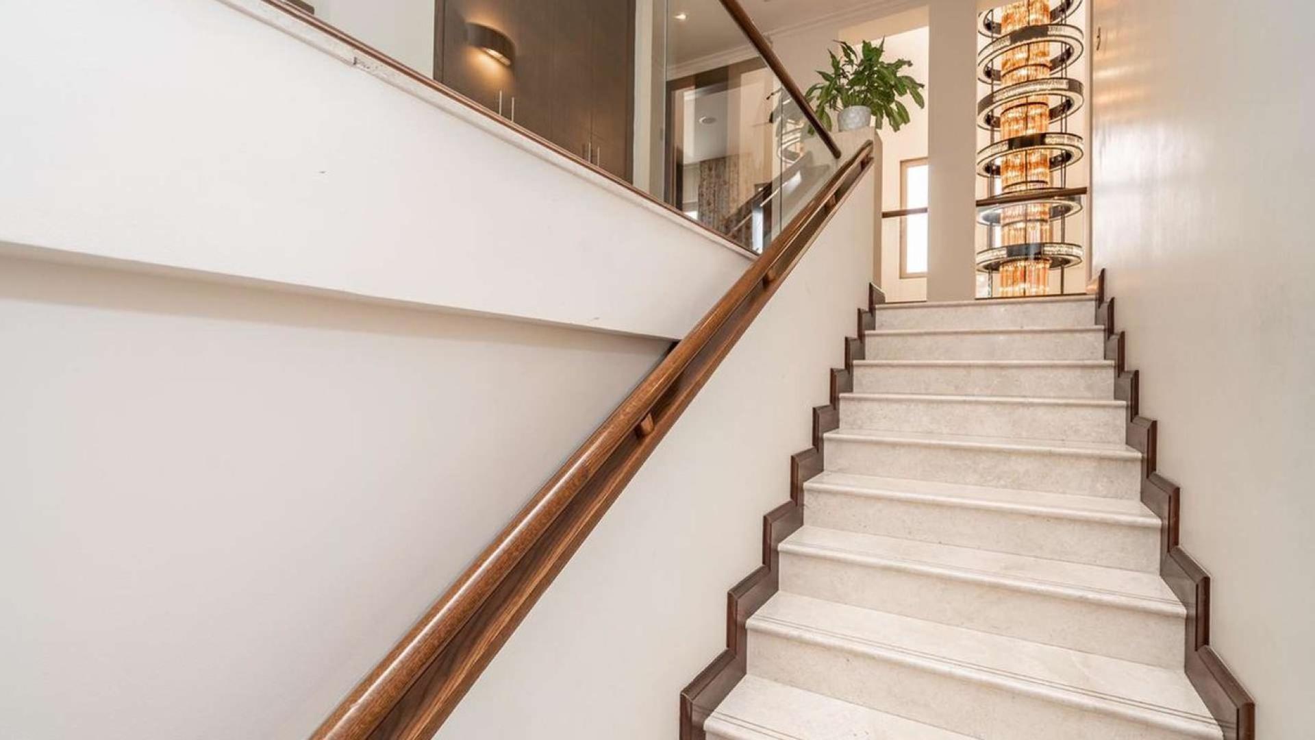 Luxurious living room in 6-bedroom villa, Al Barari, Dubai with modern decor and garden view