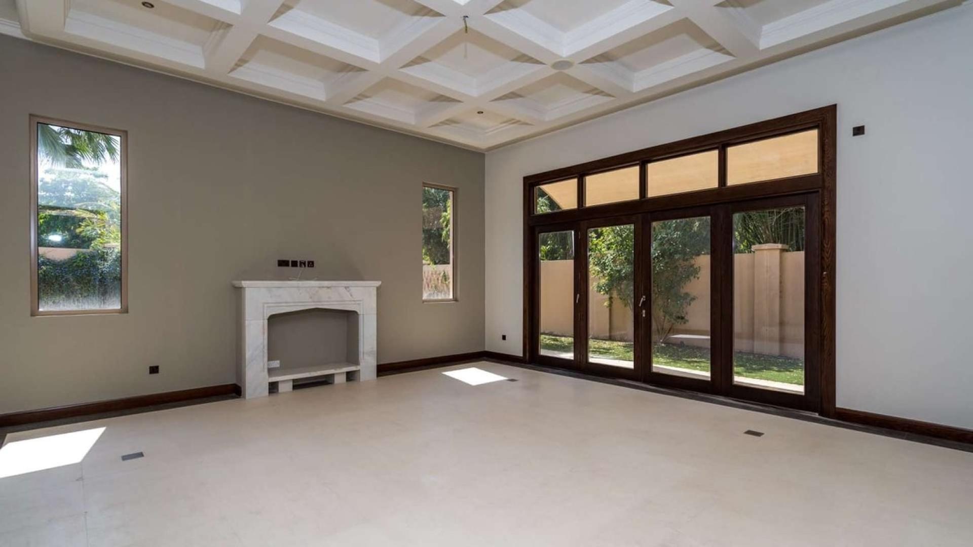 Bright hallway in six-bedroom villa, Al Barari, Ajman Uptown, featuring large windows and tiled floors