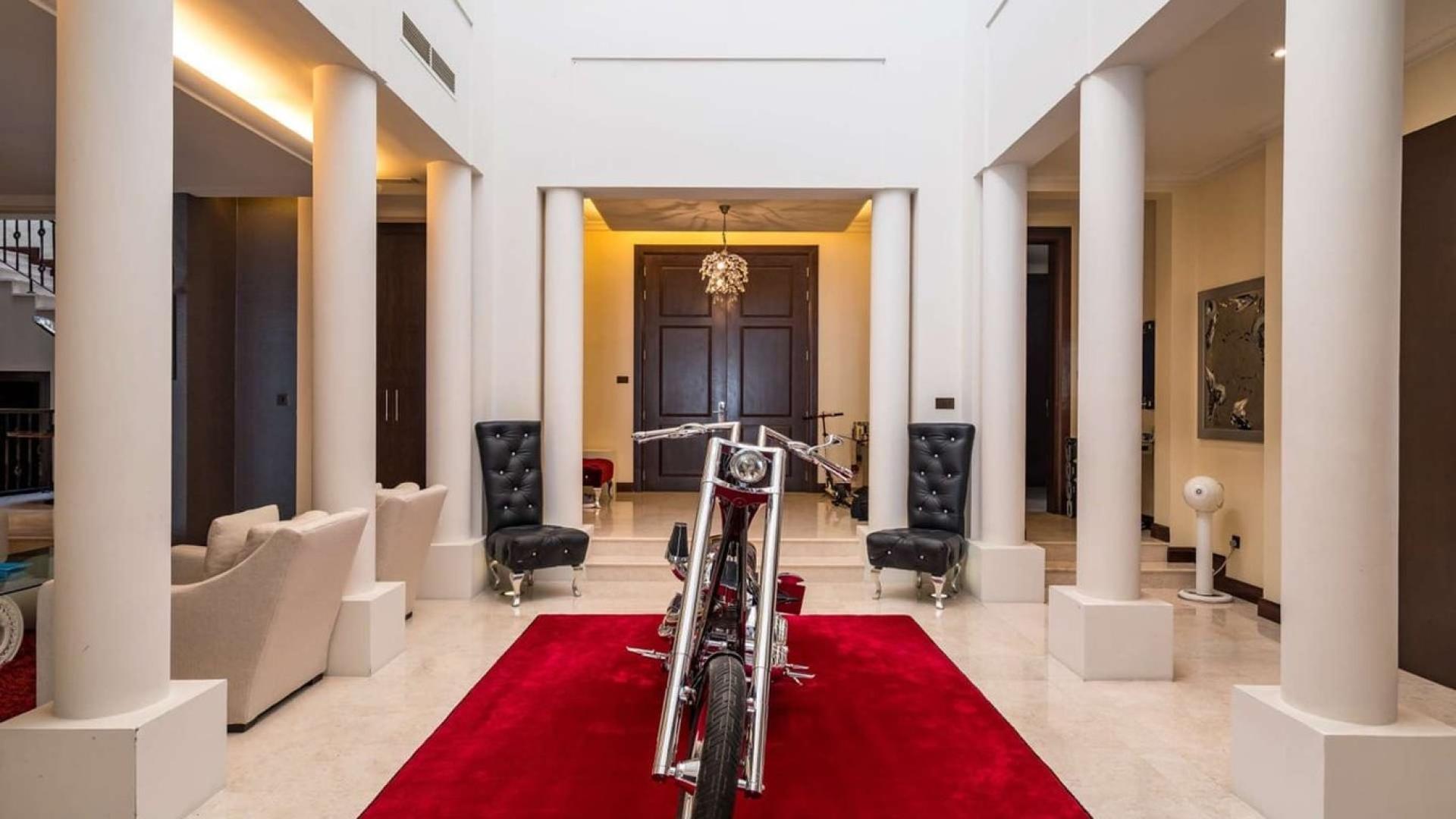 Luxurious villa interior with red carpet and stylish decor in Al Barari, Dubai