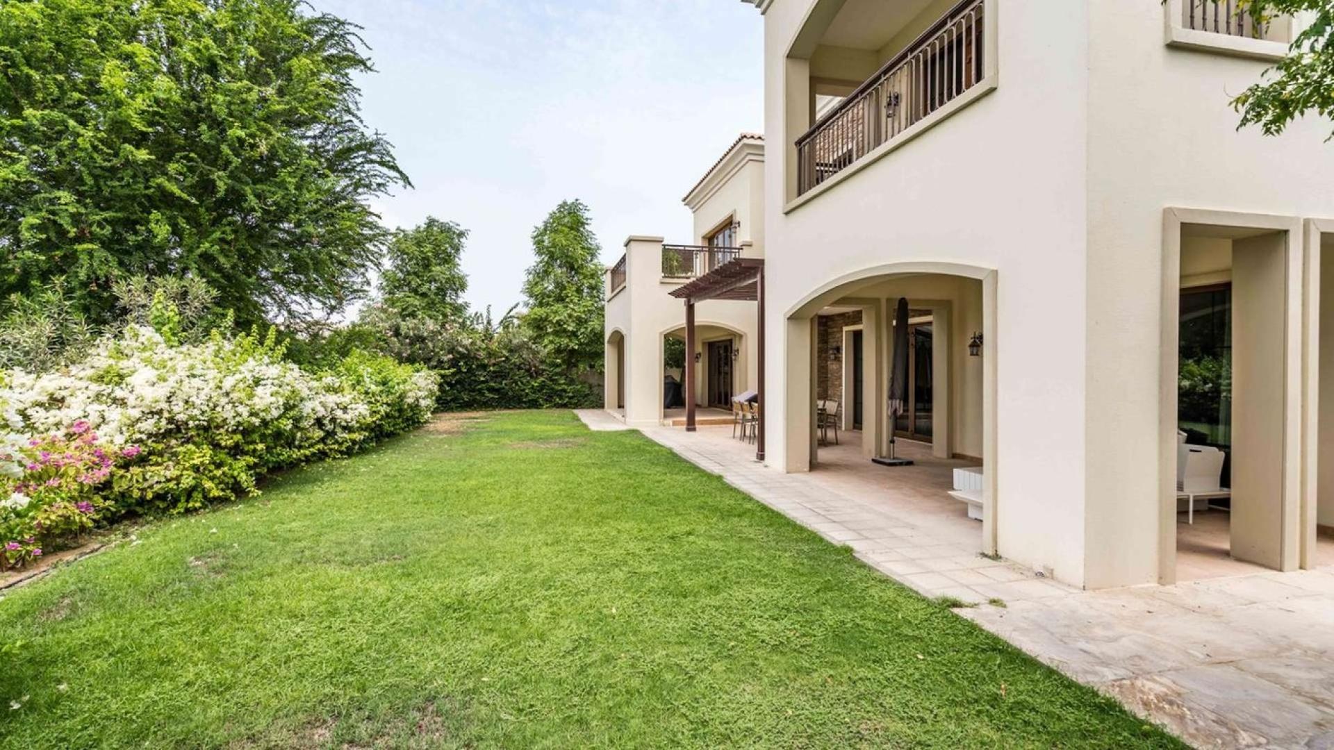 Luxurious Tarragona villa balcony view of lush greenery and serene water feature