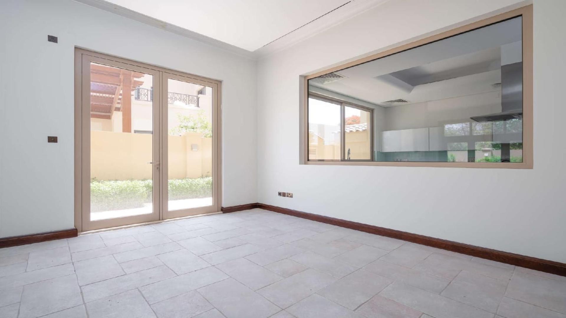 Spacious living room with large windows in Jasmine Leaf villa, Al Barari, for sale