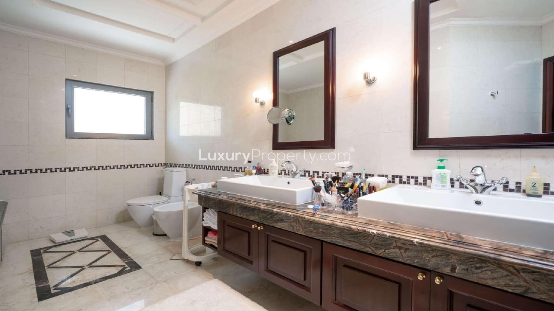 Exterior of luxury 6-bedroom Signature Villa in Palm Jumeirah, surrounded by palm trees