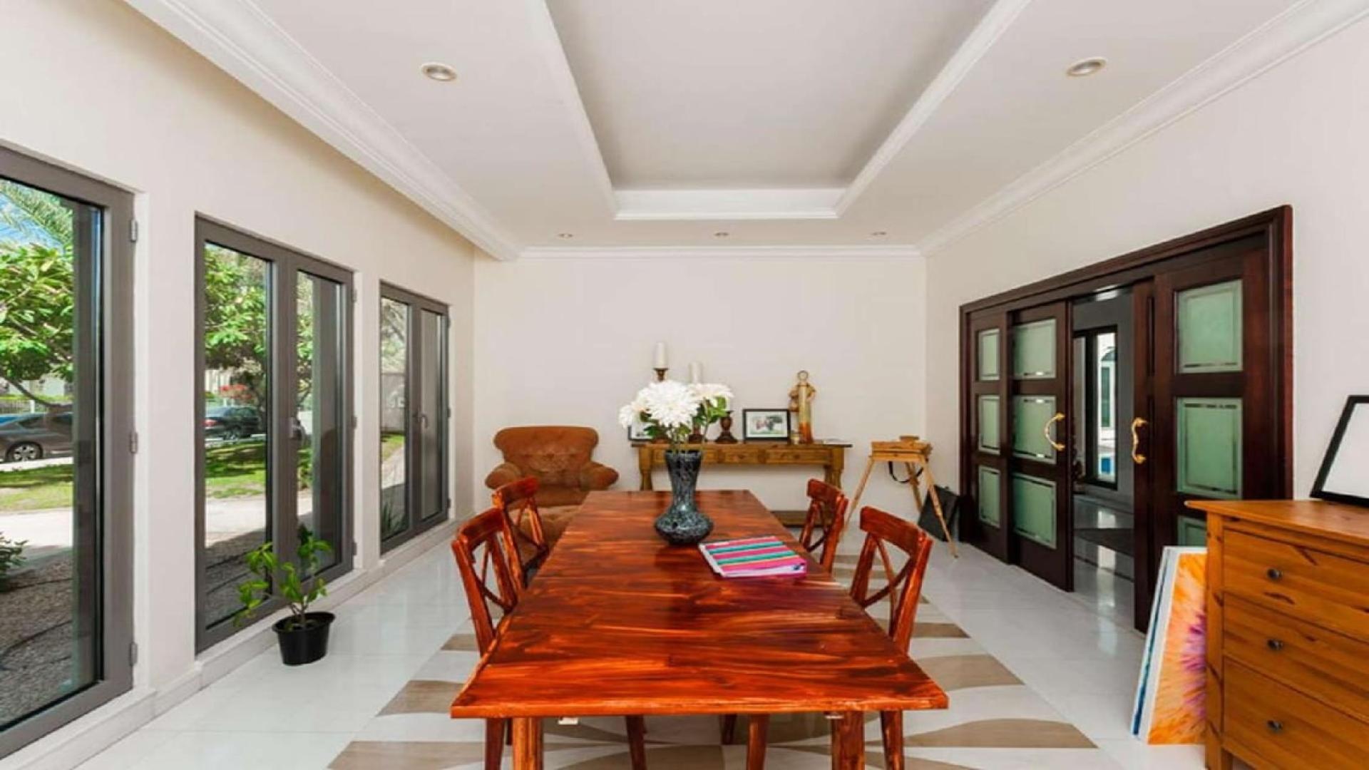 Luxurious kitchen in 6-bed Emirates Hills villa with granite countertops and wooden cabinets