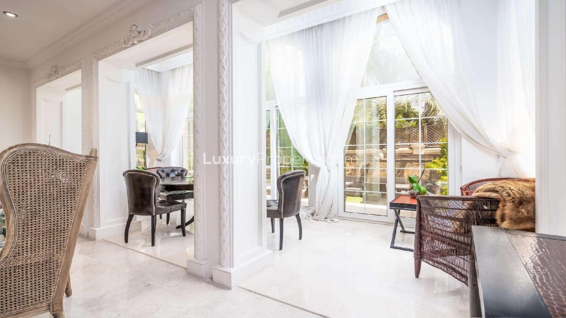 Luxury 6-bedroom villa exterior with palm trees in Emirates Hills, Dubai for sale