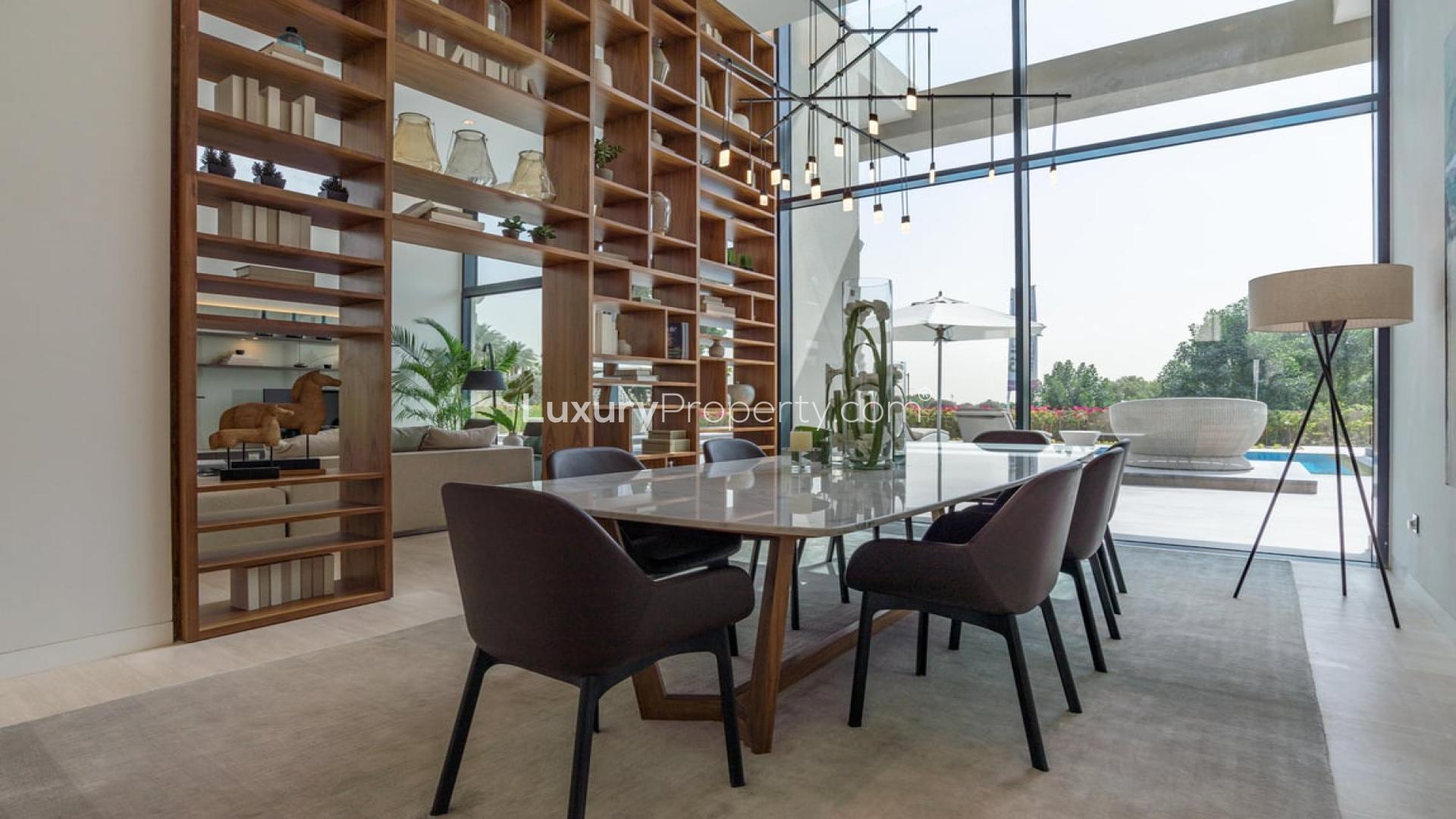 Modern dining area in luxurious villa at Jumeirah Golf Estates, featuring large windows and decor