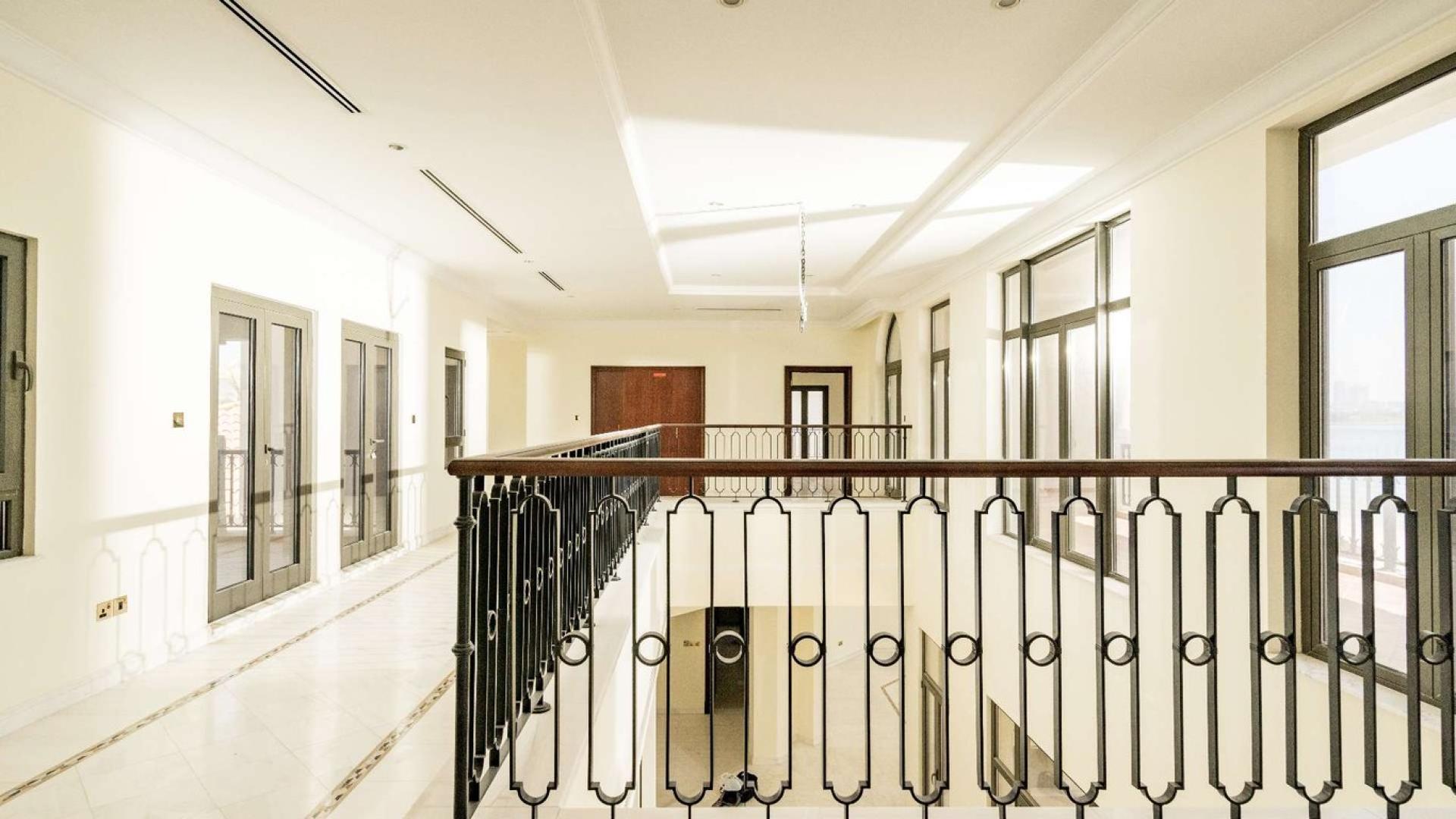 Luxurious kitchen in Palm Jumeirah villa with wooden cabinets and granite countertops