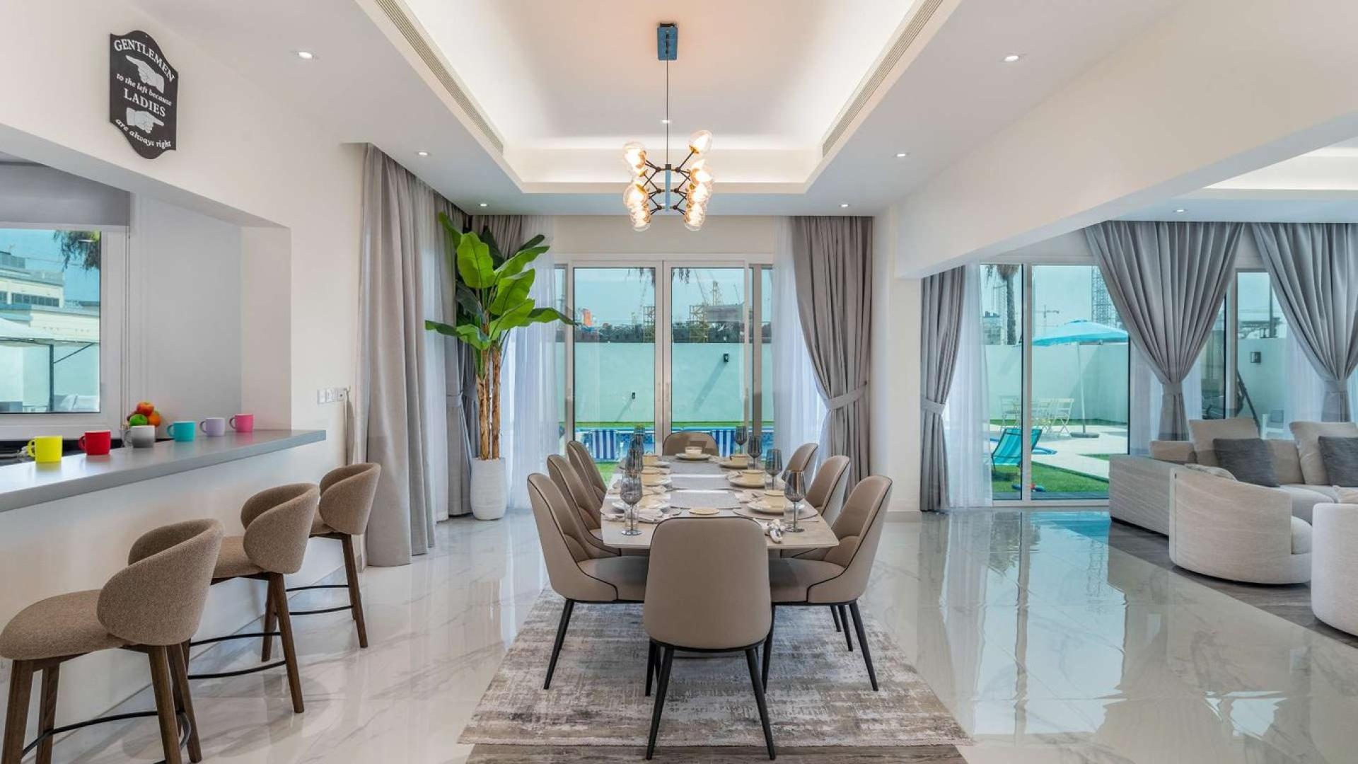 Contemporary villa dining and living area with pool view in Pearl Jumeirah, Jumeirah