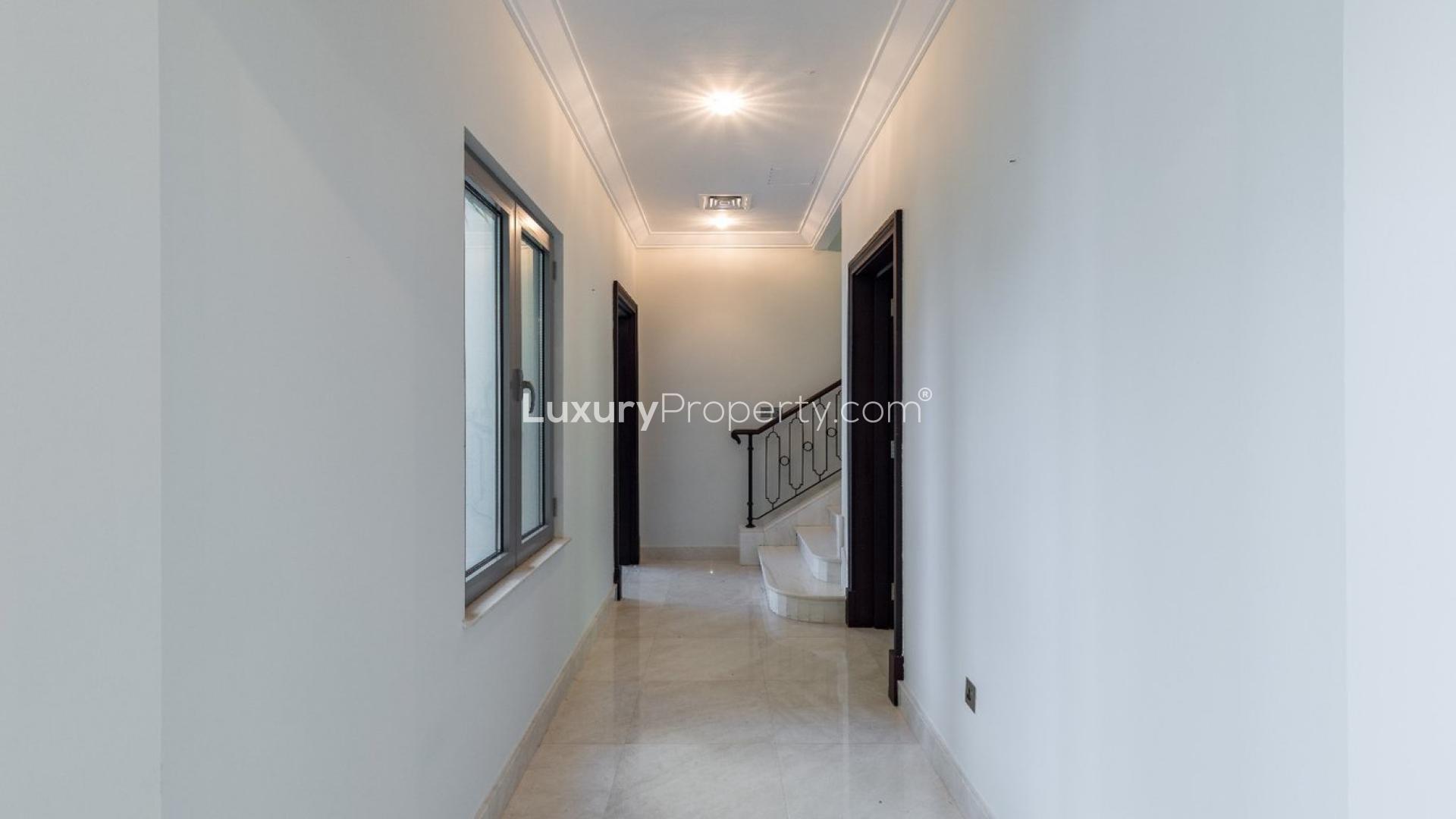 Spacious villa interior with large windows overlooking waterfront in Palm Jumeirah, Signature Villas