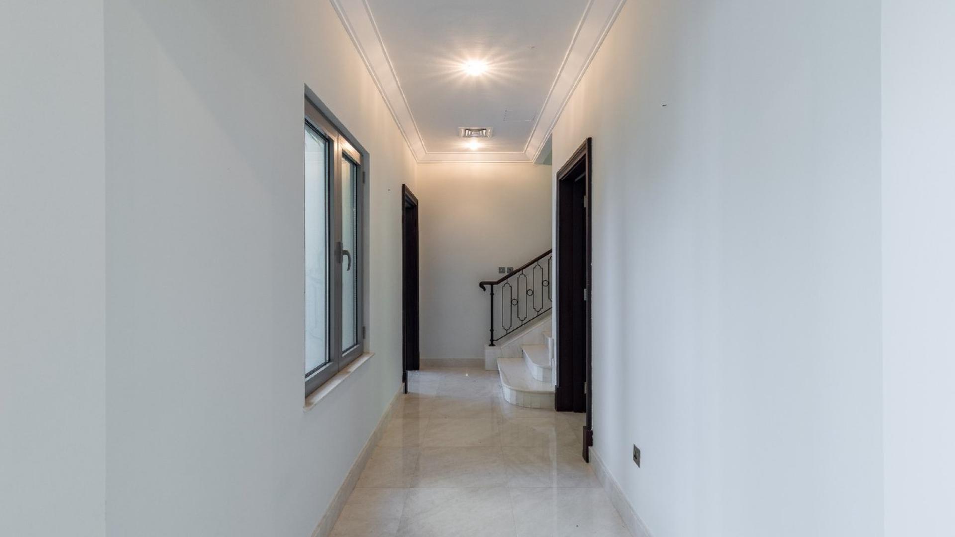 Spacious villa interior with large windows overlooking waterfront in Palm Jumeirah, Signature Villas