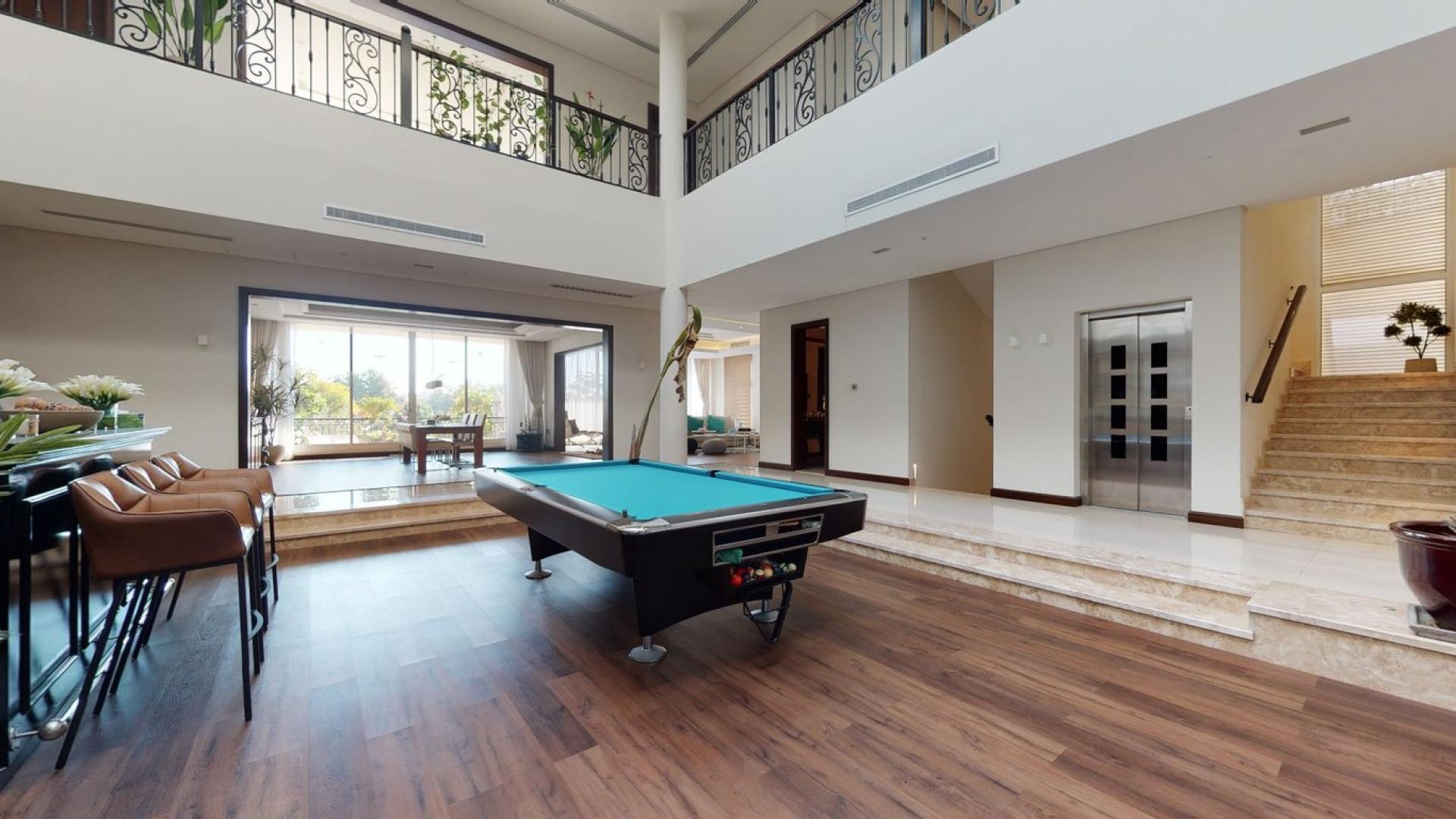Luxurious villa interior with spacious living area and pool table, Jumeirah Golf Estates