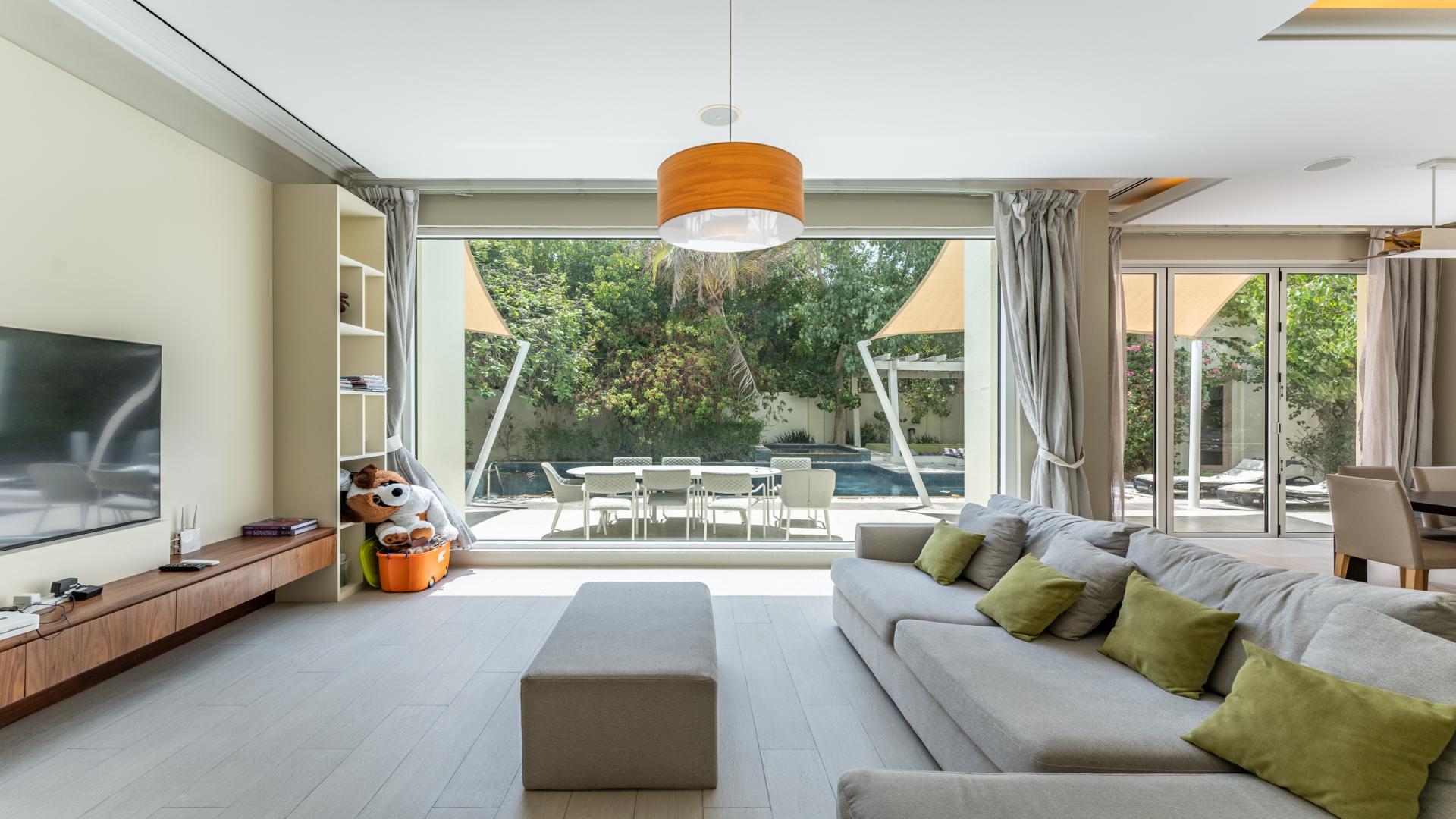 Outdoor pool and patio of upgraded Bromellia Mansion in Al Barari Villas, Dubai