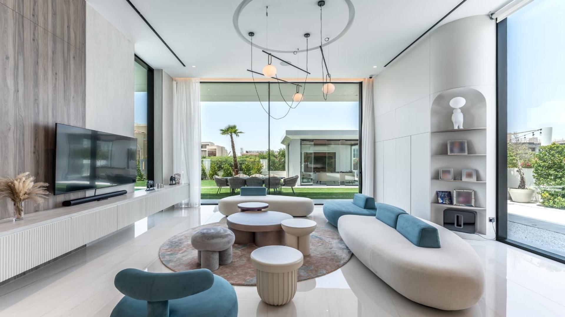 Luxurious living room in Dubai Hills Estate villa with modern decor and large windows