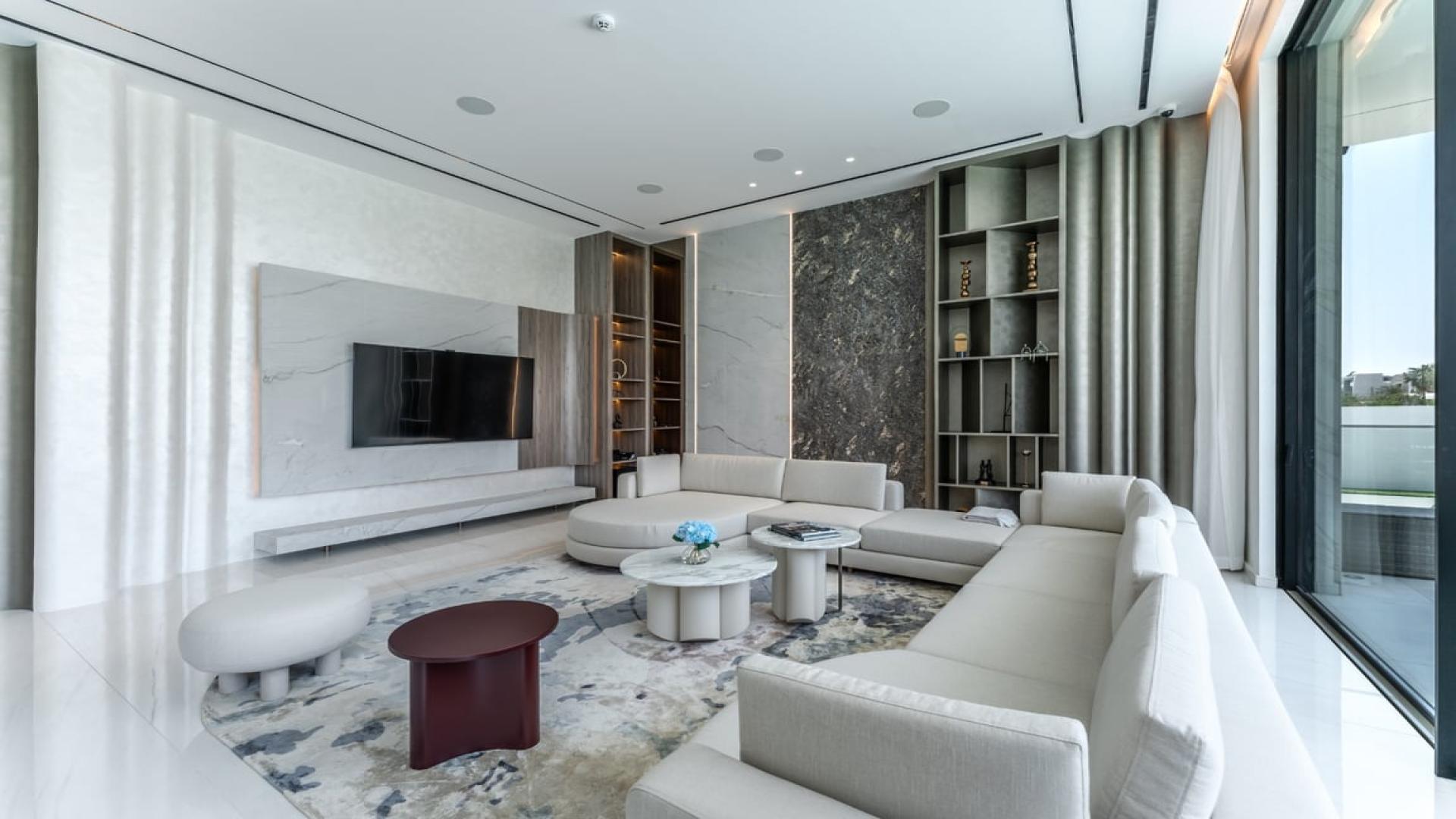 Modern dining room with elegant decor in Dubai Hills Estate villa, featuring large glass doors