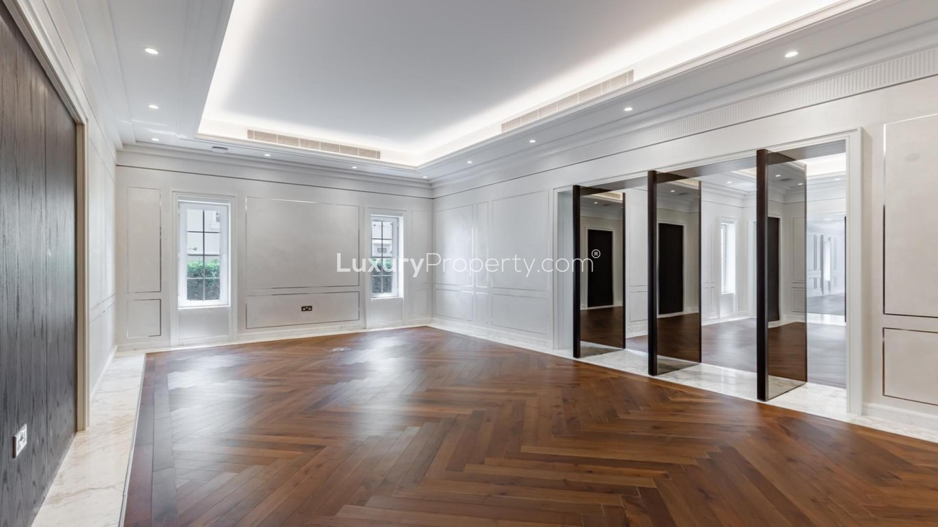 Spacious living room in 6-bedroom Polo Homes villa, Arabian Ranches, hardwood floors, large windows