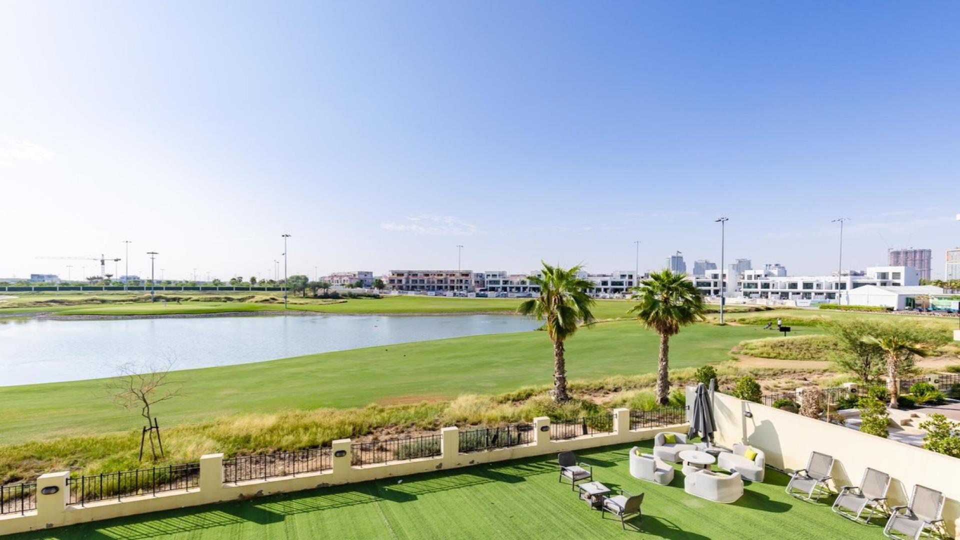 Luxurious villa living room with pool table, spacious seating, and large windows in Damac Hills