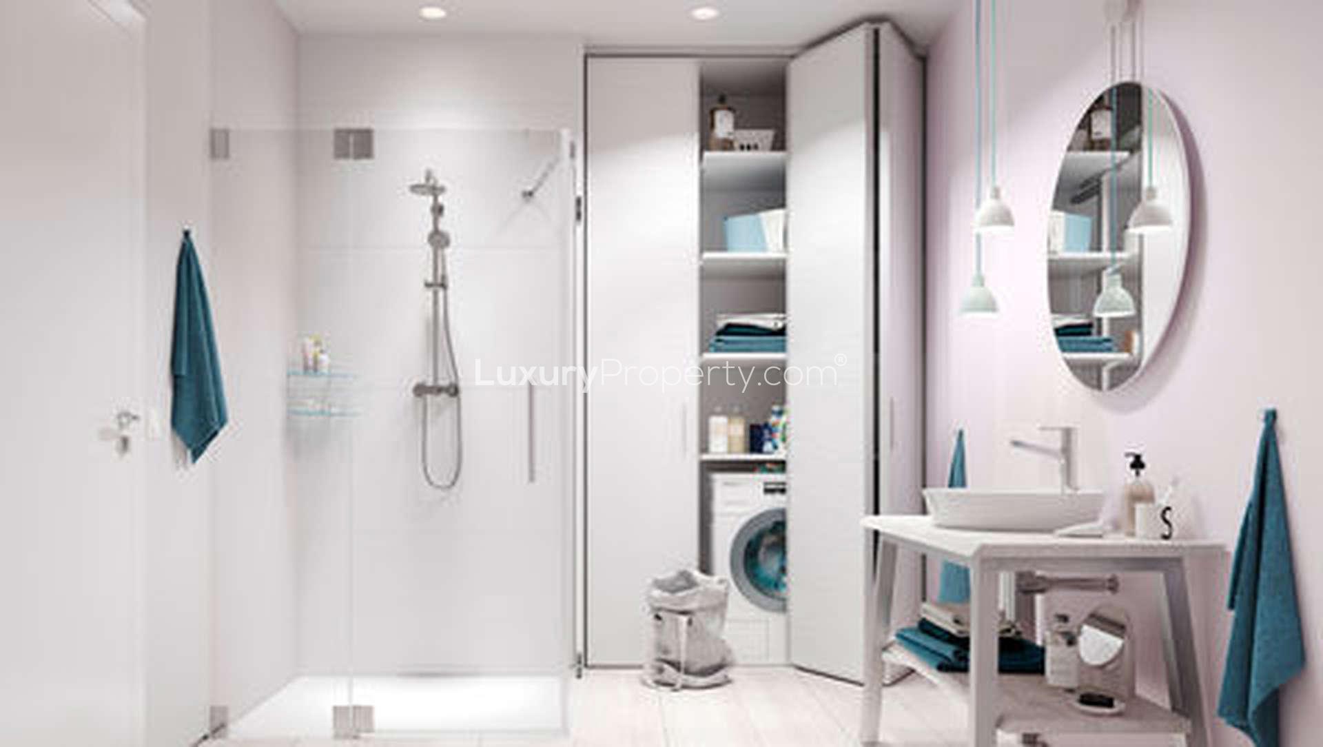 Modern bathroom with shower and laundry area at The Residences, Lagos apartment for sale
