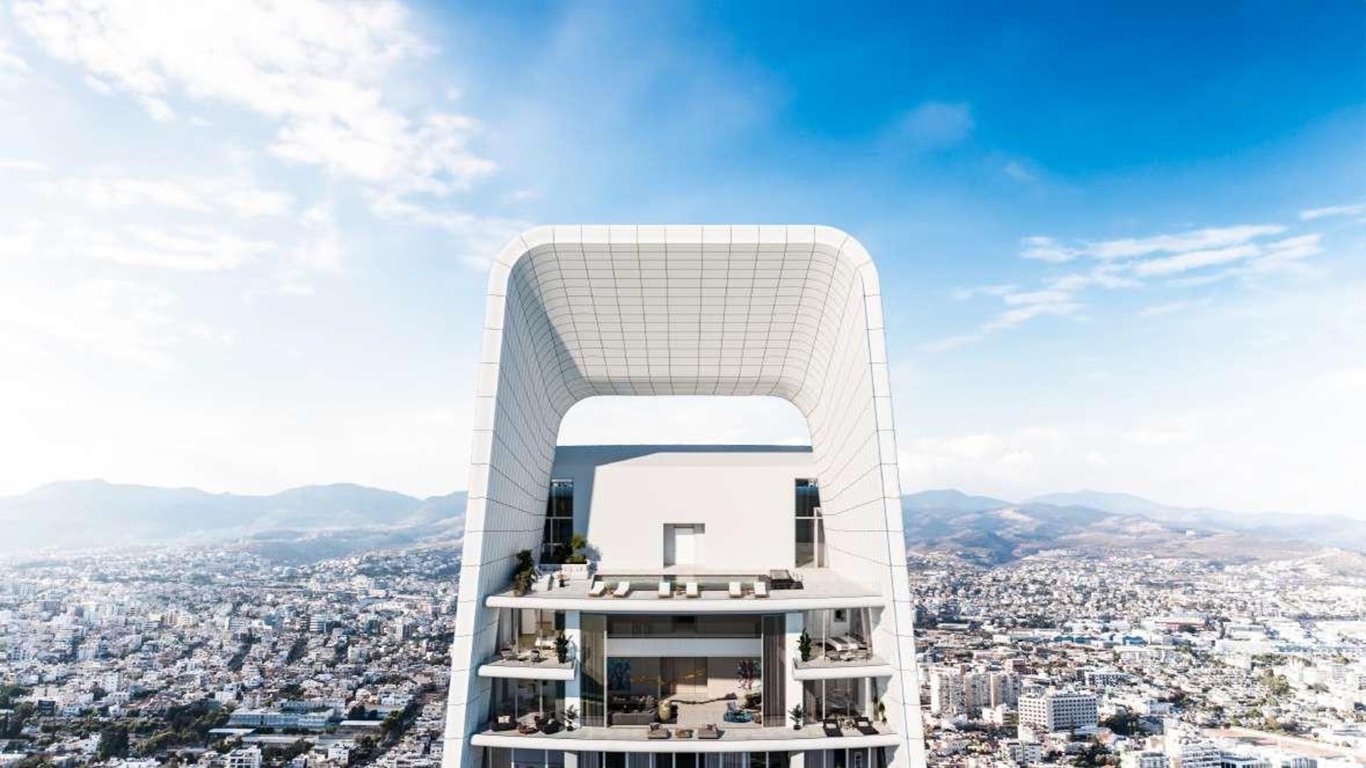 Luxurious penthouse living room with ocean view, modern furniture, and elegant staircase in Limassol