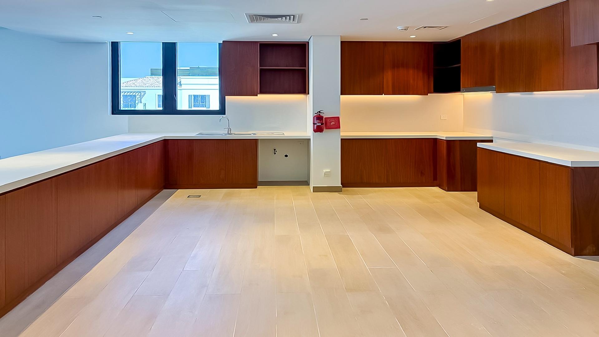 "Spacious modern kitchen in luxury 6-bedroom penthouse, La Sirene, Jumeirah for sale.",Balcony view from luxury penthouse at La Sirene, Jumeirah overlooking marina and buildings