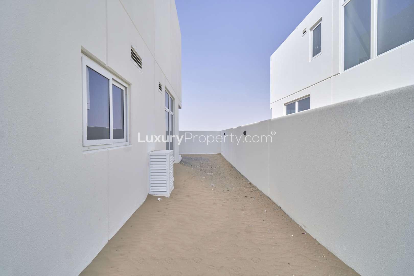 Modern kitchen in 6-bed villa, Adria Villas, Damac Hills 2, featuring sleek cabinetry and countertops