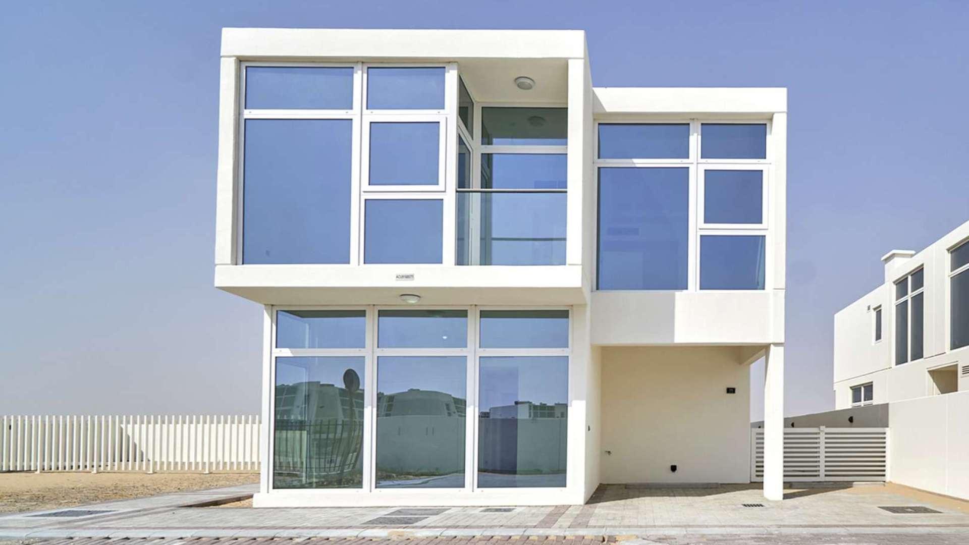 Spacious 6-bedroom Adria Villa exterior with large sandy garden in Damac Hills 2