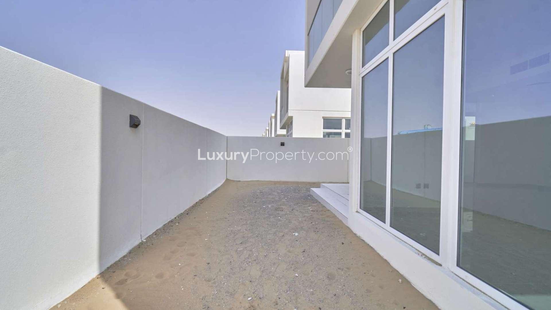 Modern 6-bedroom Adria Villa exterior in Damac Hills 2 with large windows and garden space