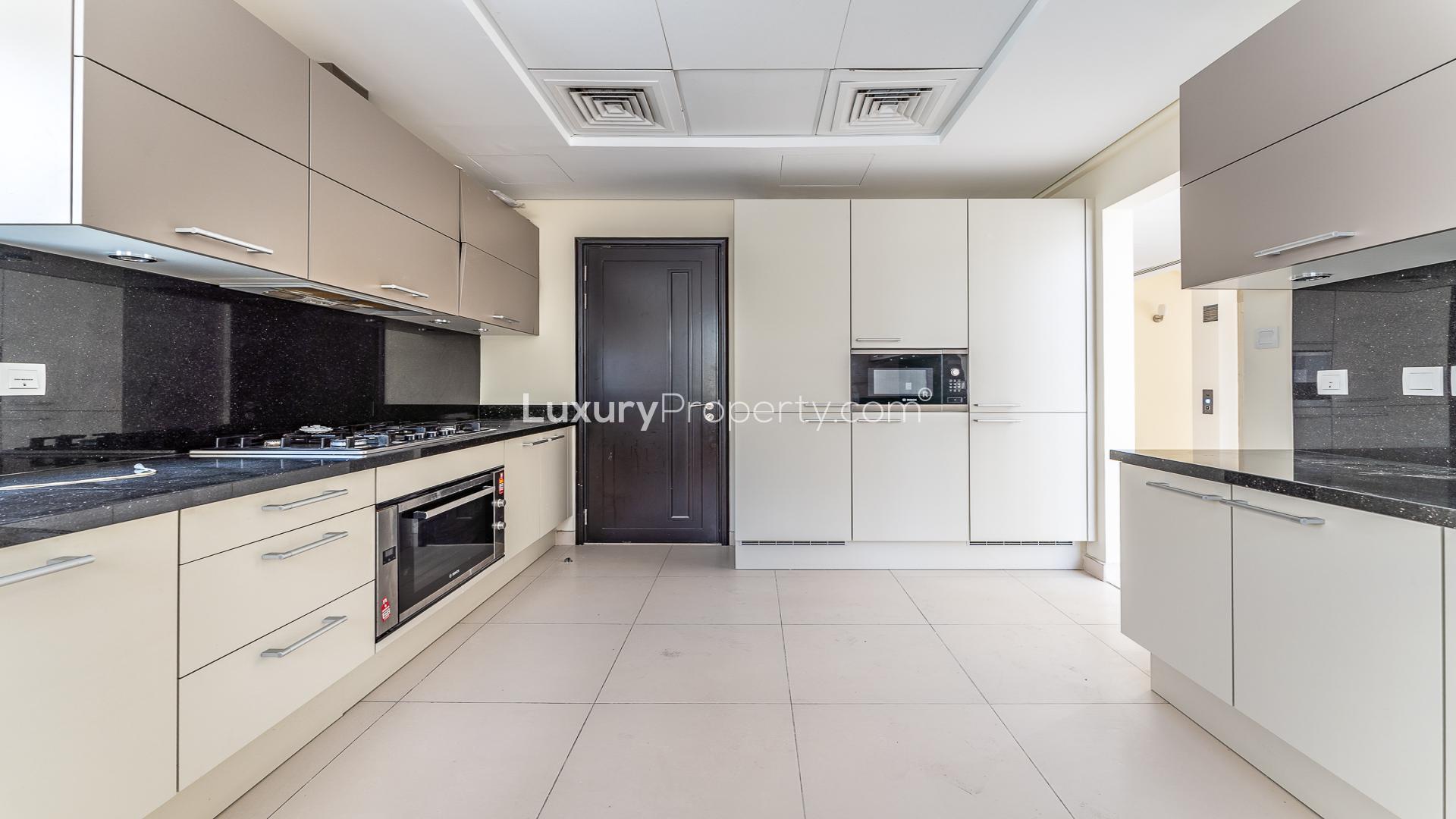 Spacious living room with floor-to-ceiling windows in Meydan Gated Community villa