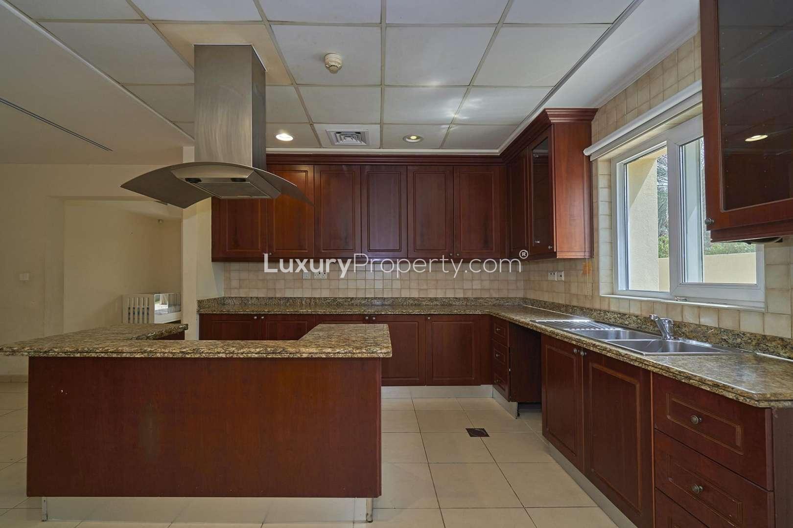 Exterior view of 6-bedroom villa in Al Mahra, Arabian Ranches, with lush greenery