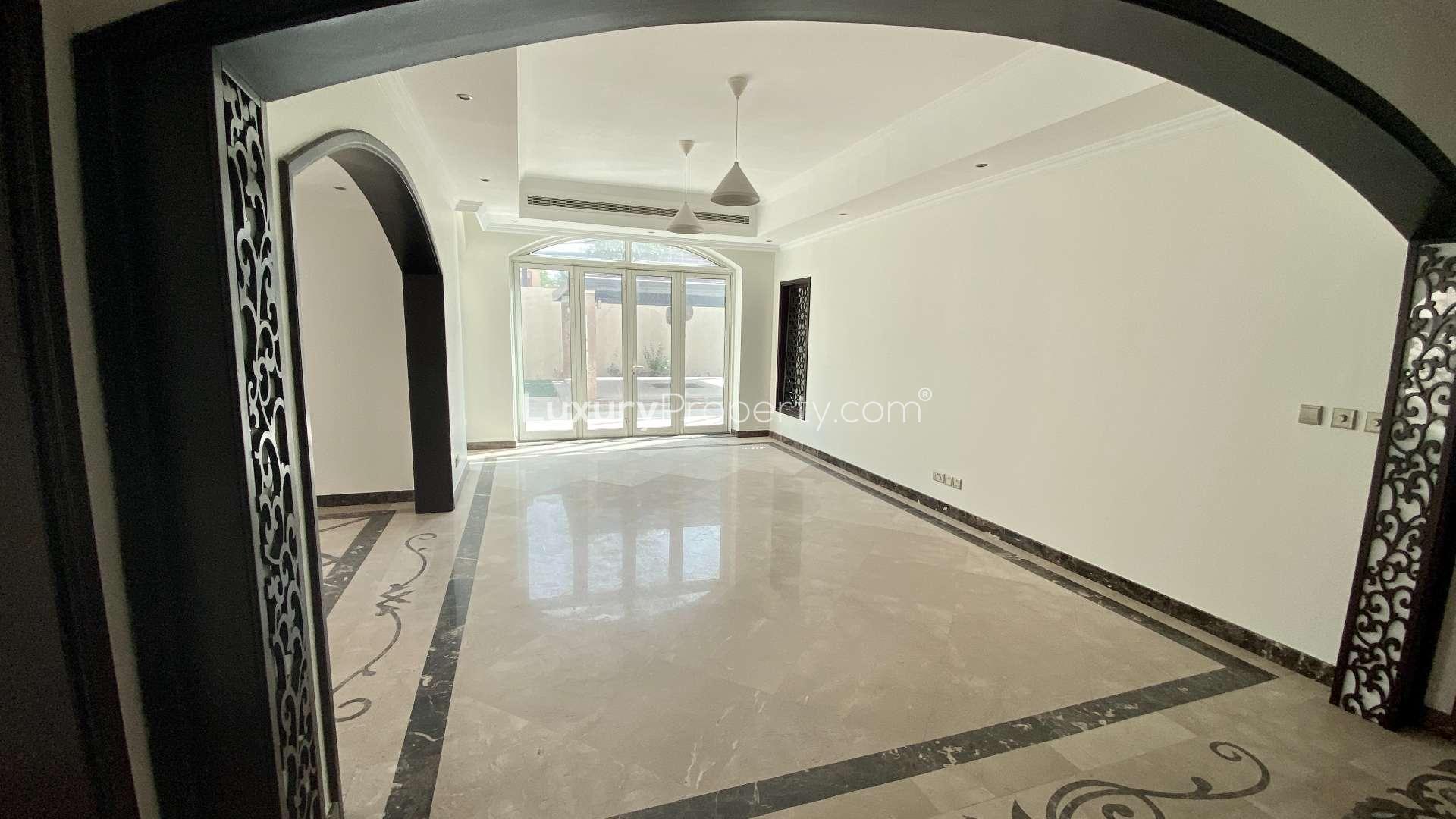 Luxurious Al Mahra villa garden with gazebo, palm trees, and spacious patio area