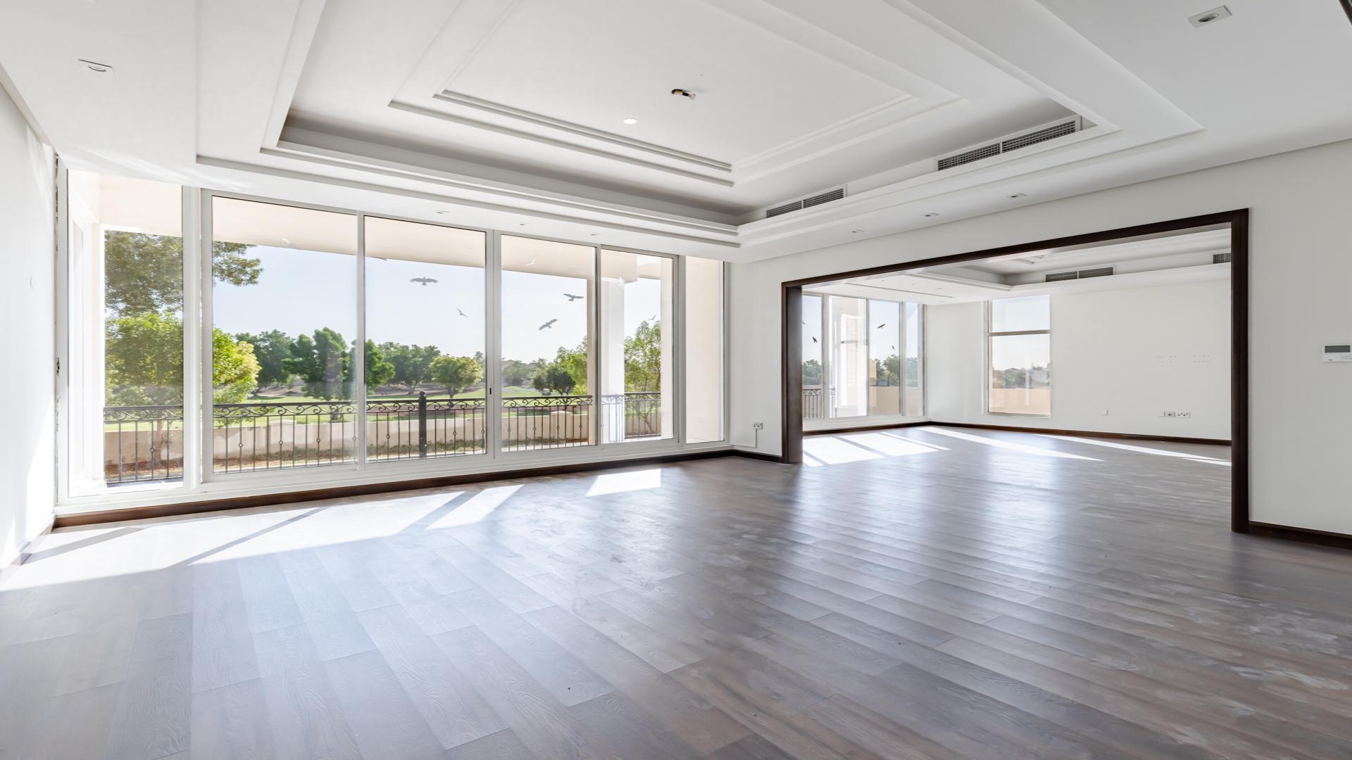 N/A,Spacious living room in luxury Jumeirah Golf Estates villa with large windows and garden view