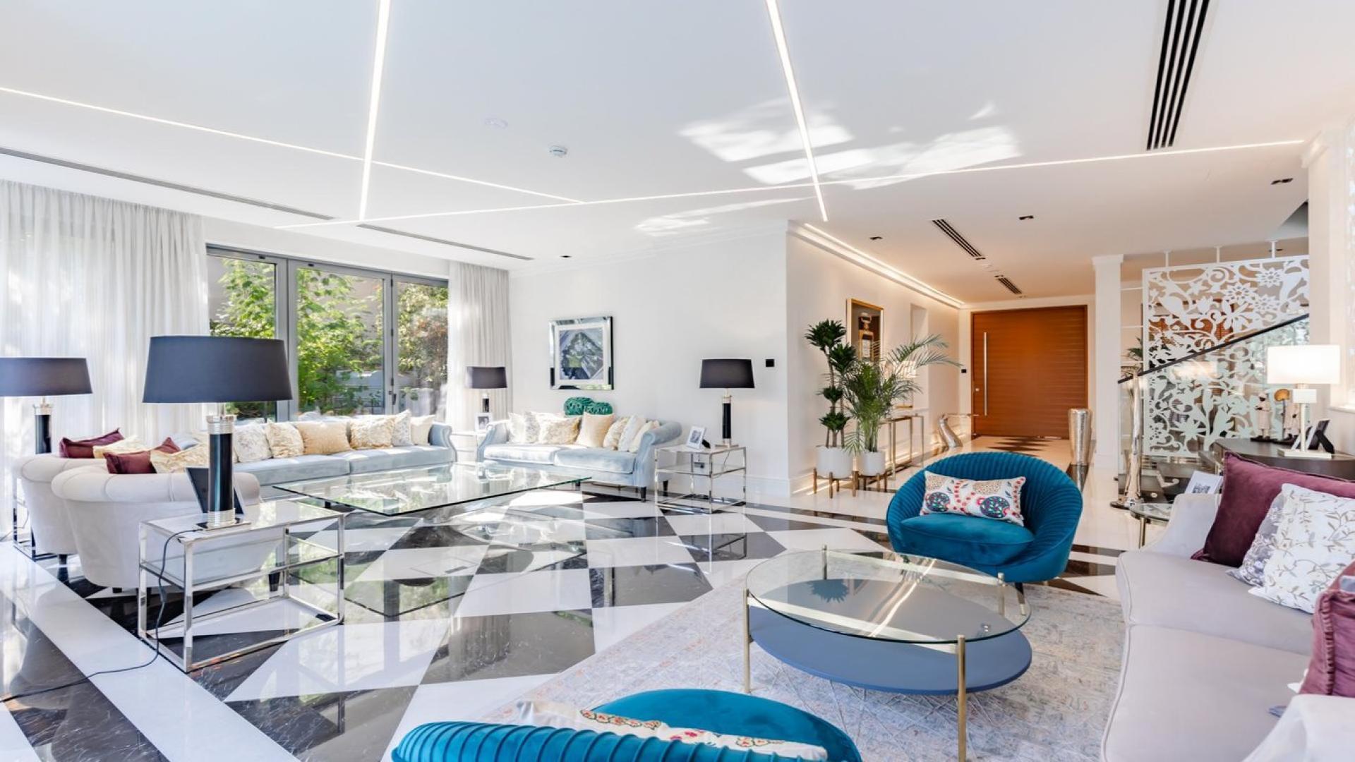 Luxurious Jumeirah Islands villa with private pool, modern design, and lush greenery at dusk