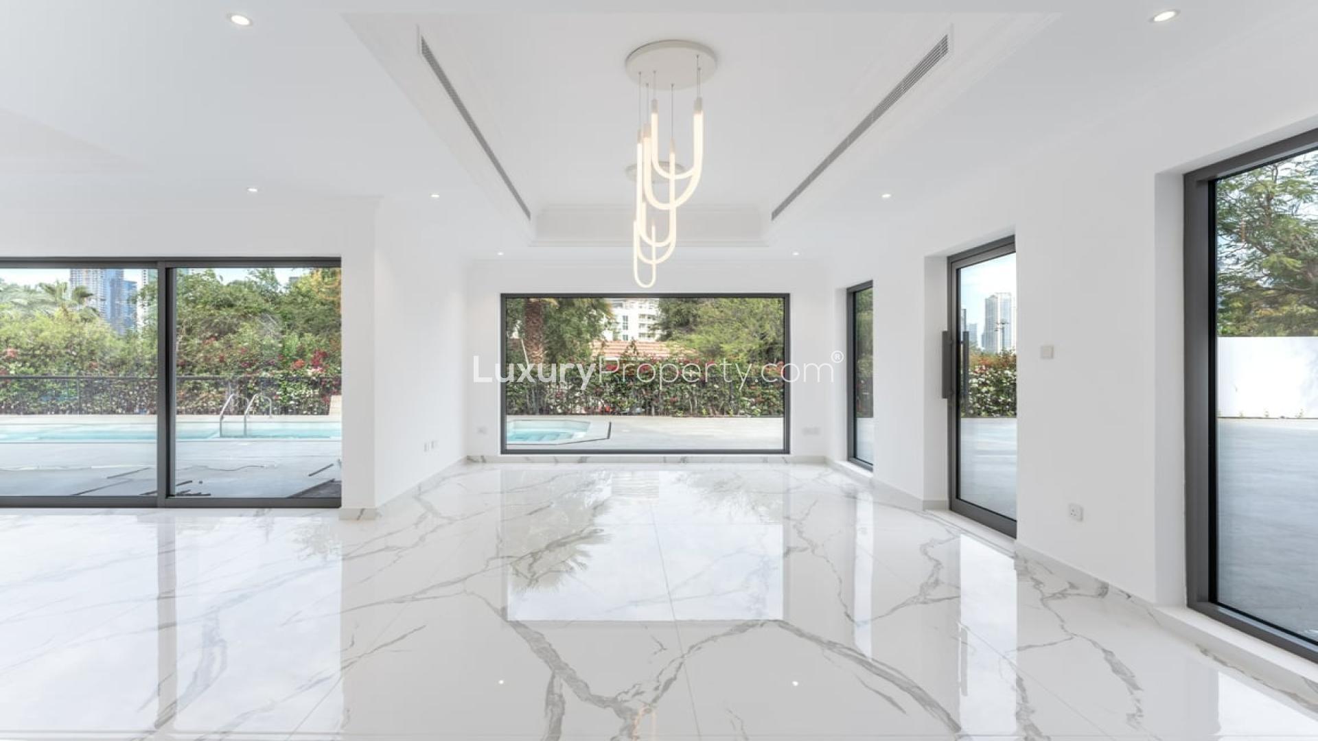 Bright living area with pool view in Jumeirah Islands villa for rent