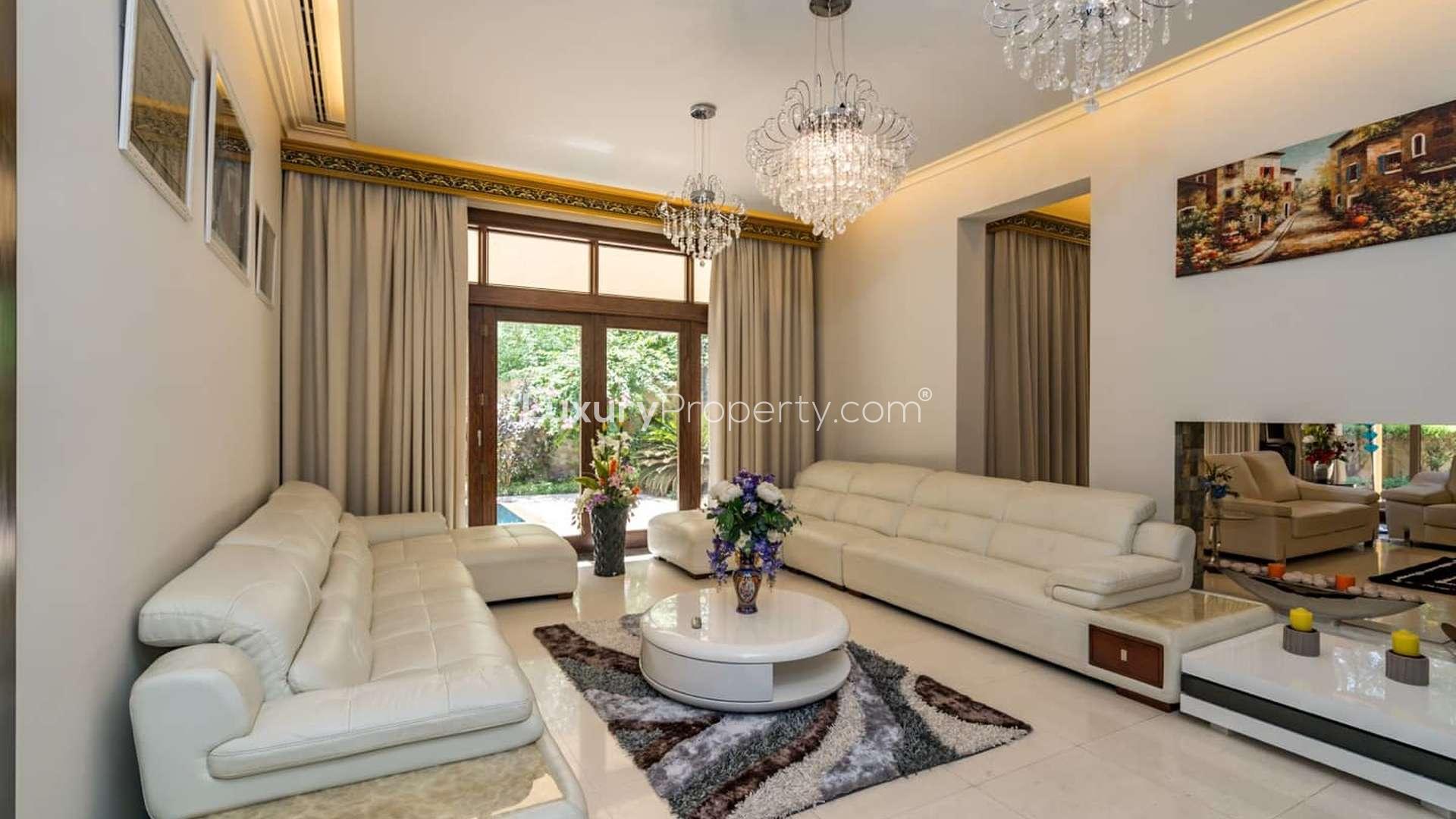 Modern kitchen in luxury 6-bedroom Bromelia villa, Al Barari, with sleek countertops and appliances