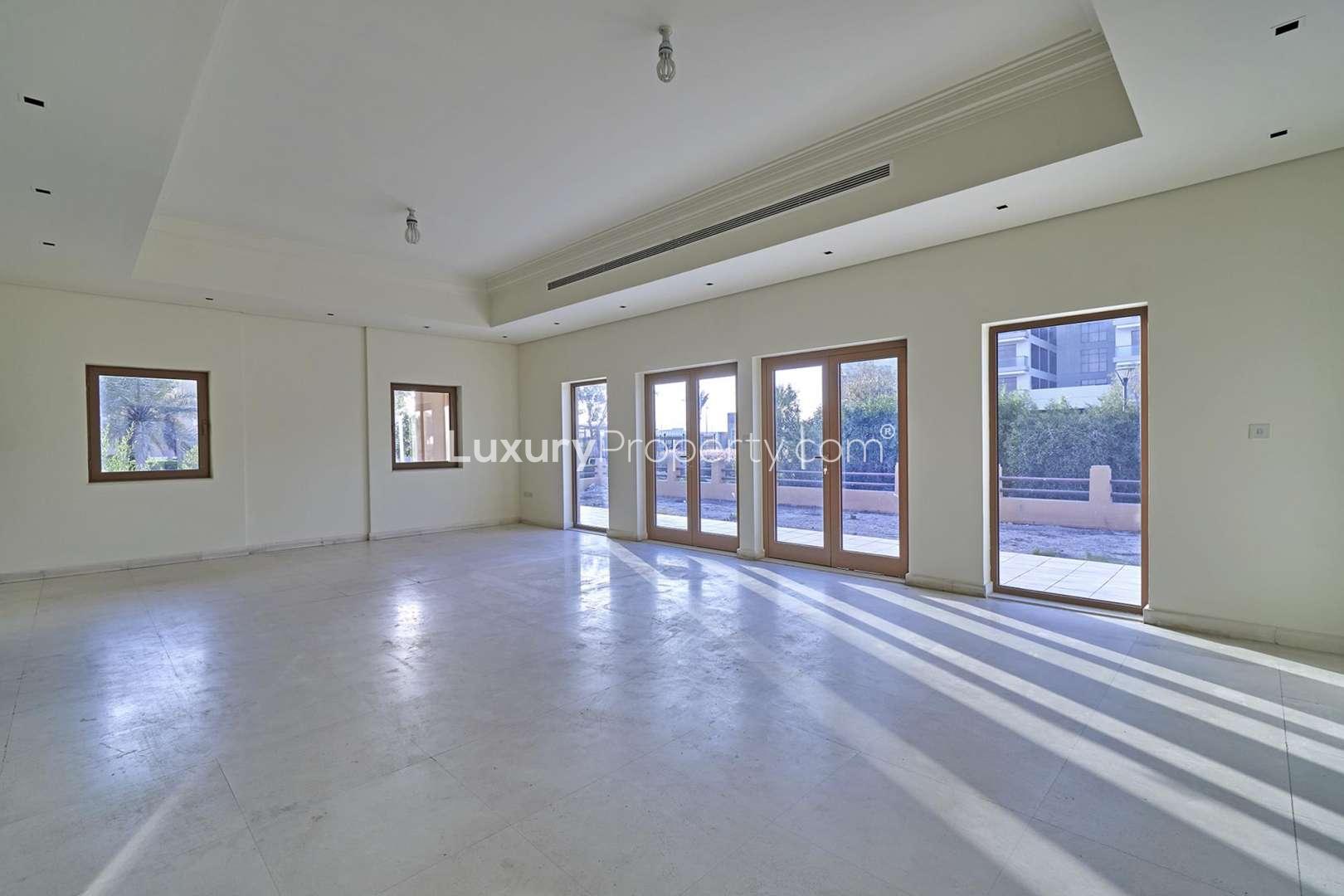Spacious living room with sliding doors in 6-bedroom villa, Al Furjan North Village