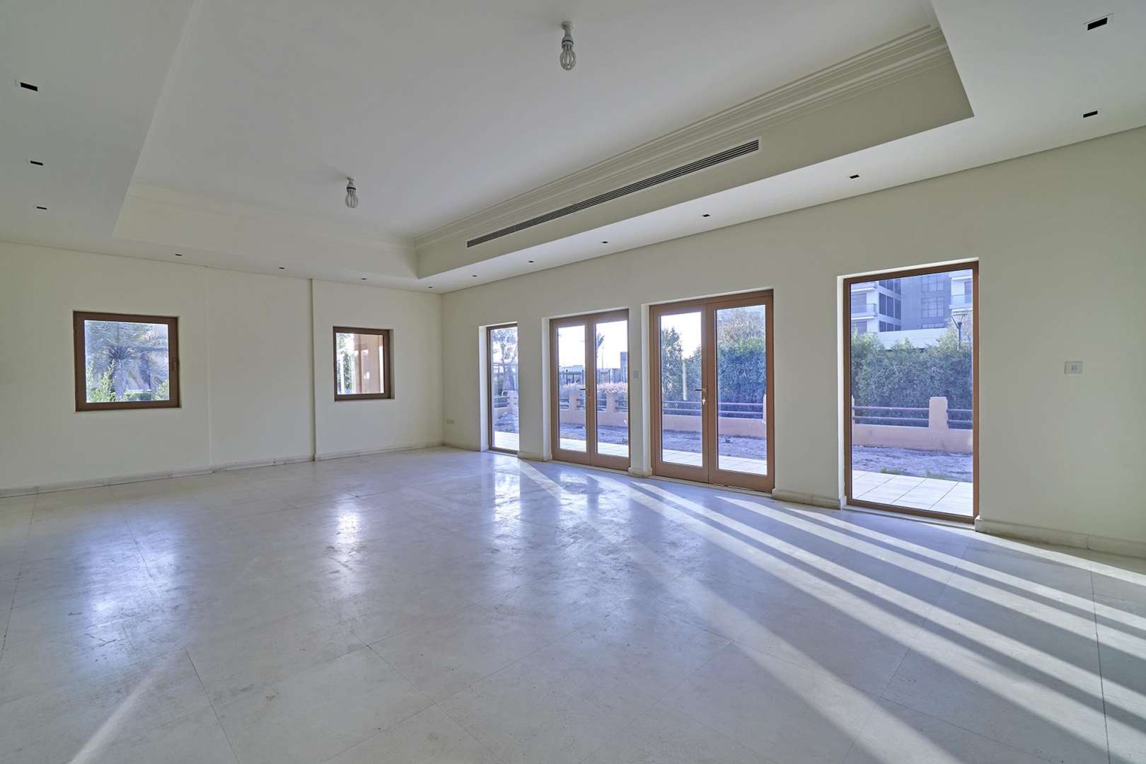 Spacious living room with sliding doors in 6-bedroom villa, Al Furjan North Village
