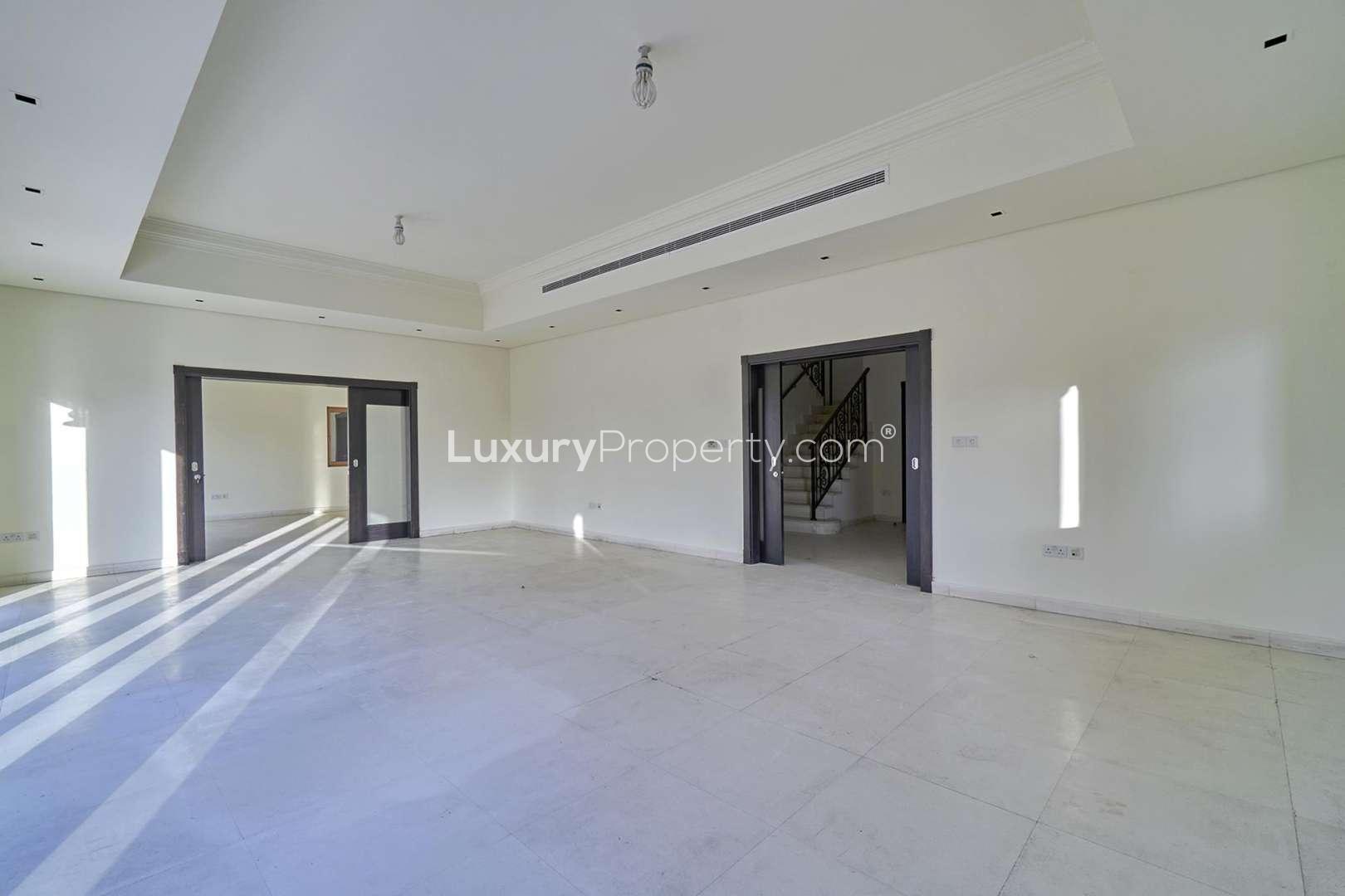 Spacious living room in 6-bed villa, Al Furjan North Village, with large windows