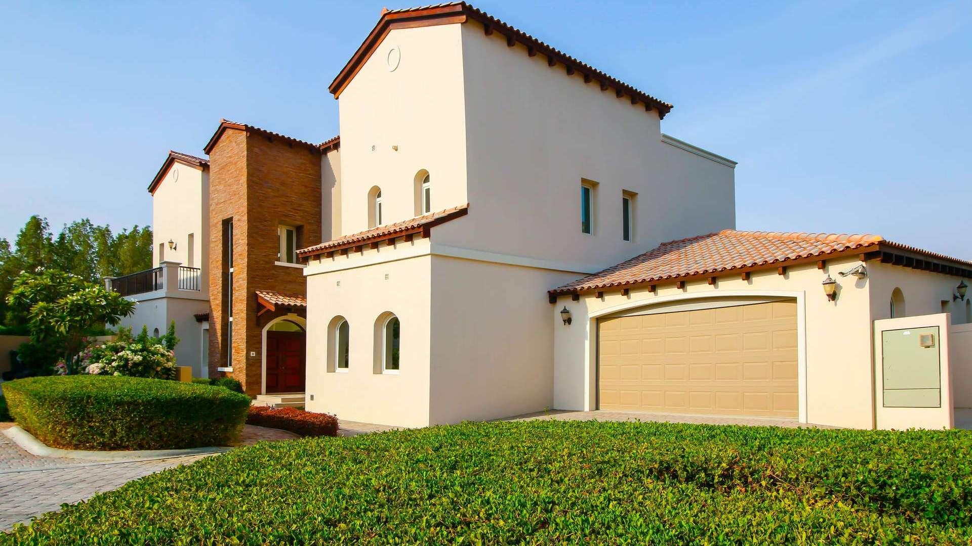 Spacious villa living room with garden views at Jumeirah Golf Estates, Earth community