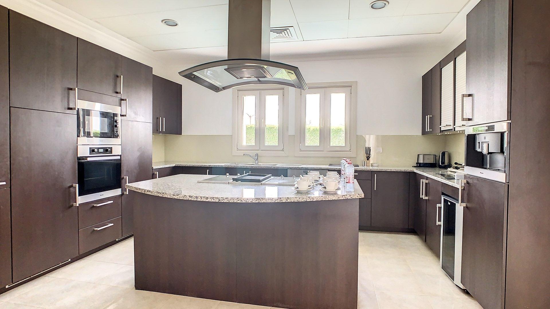 Contemporary dining room in furnished villa, Jumeirah Golf Estates, with elegant decor and art