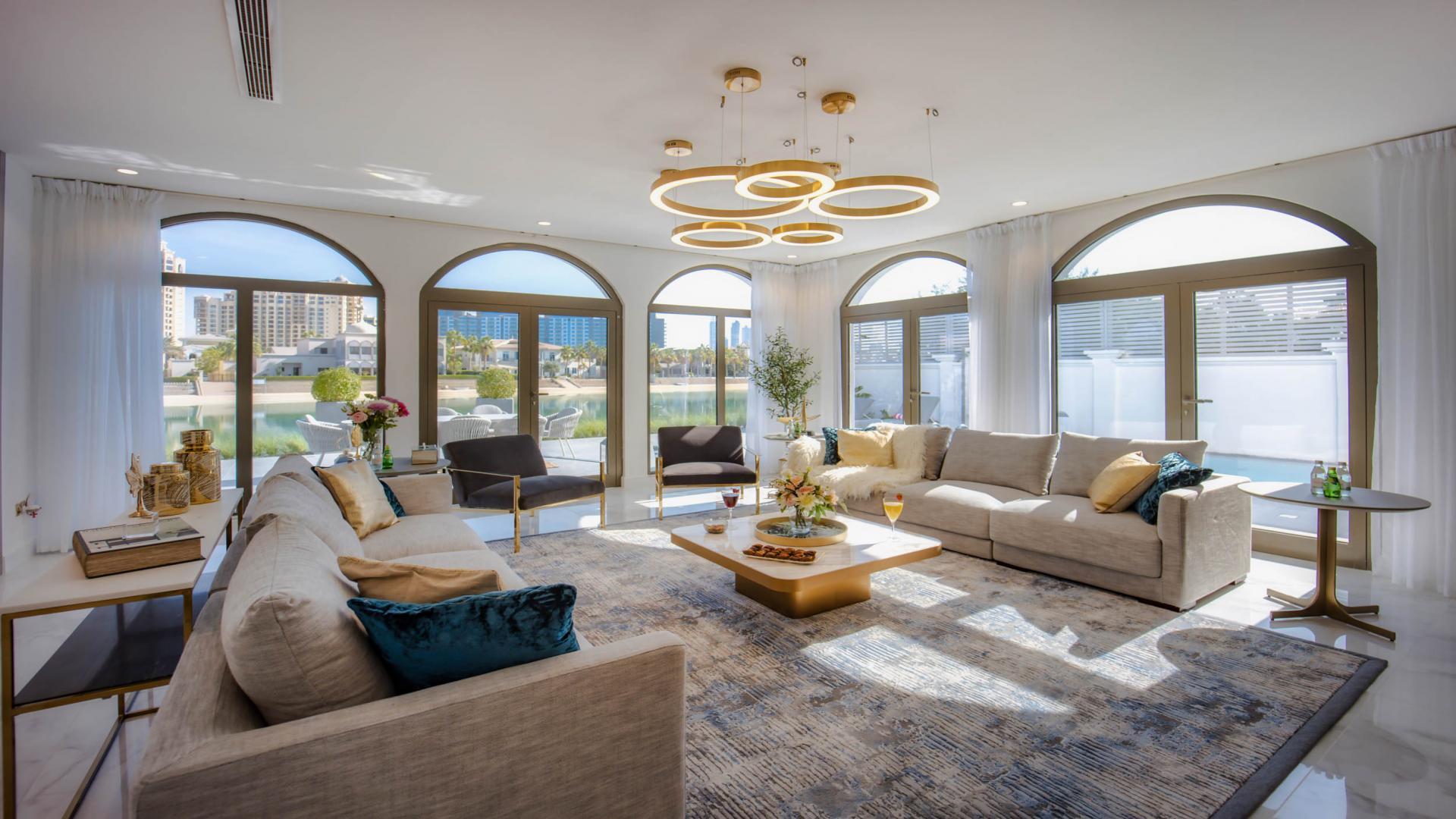 Luxurious living room in upgraded 6-bedroom villa, Palm Jumeirah, with elegant decor and marina views