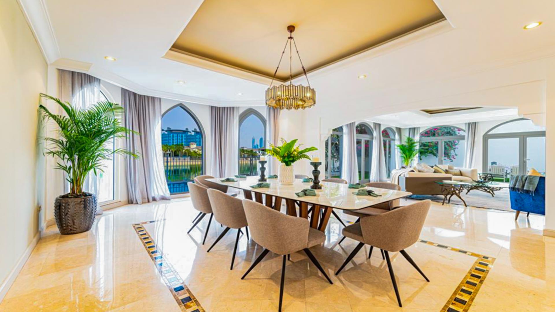 Luxurious living room in furnished Palm Jumeirah villa with garden view and modern decor