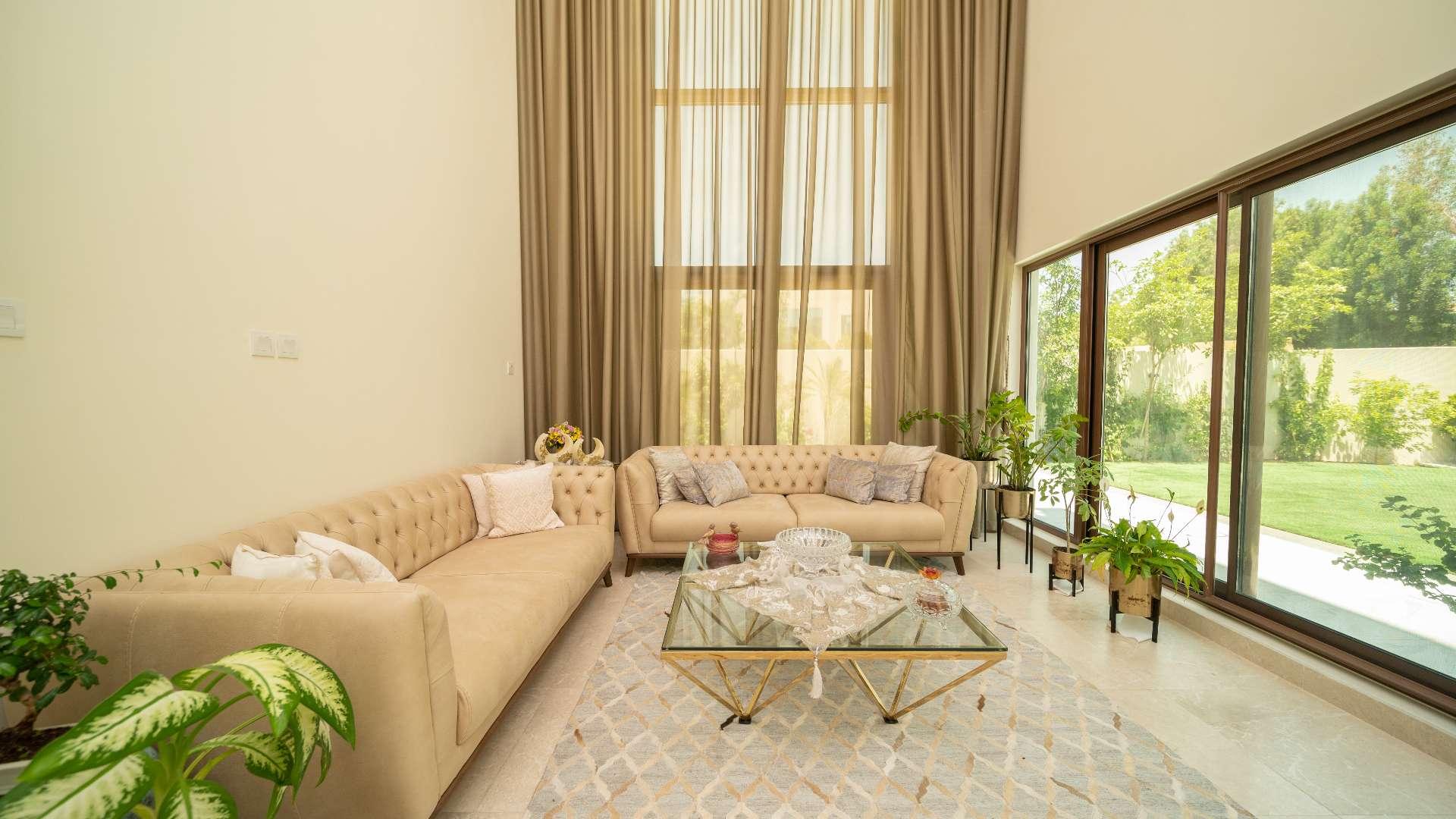 Luxurious open-plan living area in Meydan villa with elegant decor and garden views