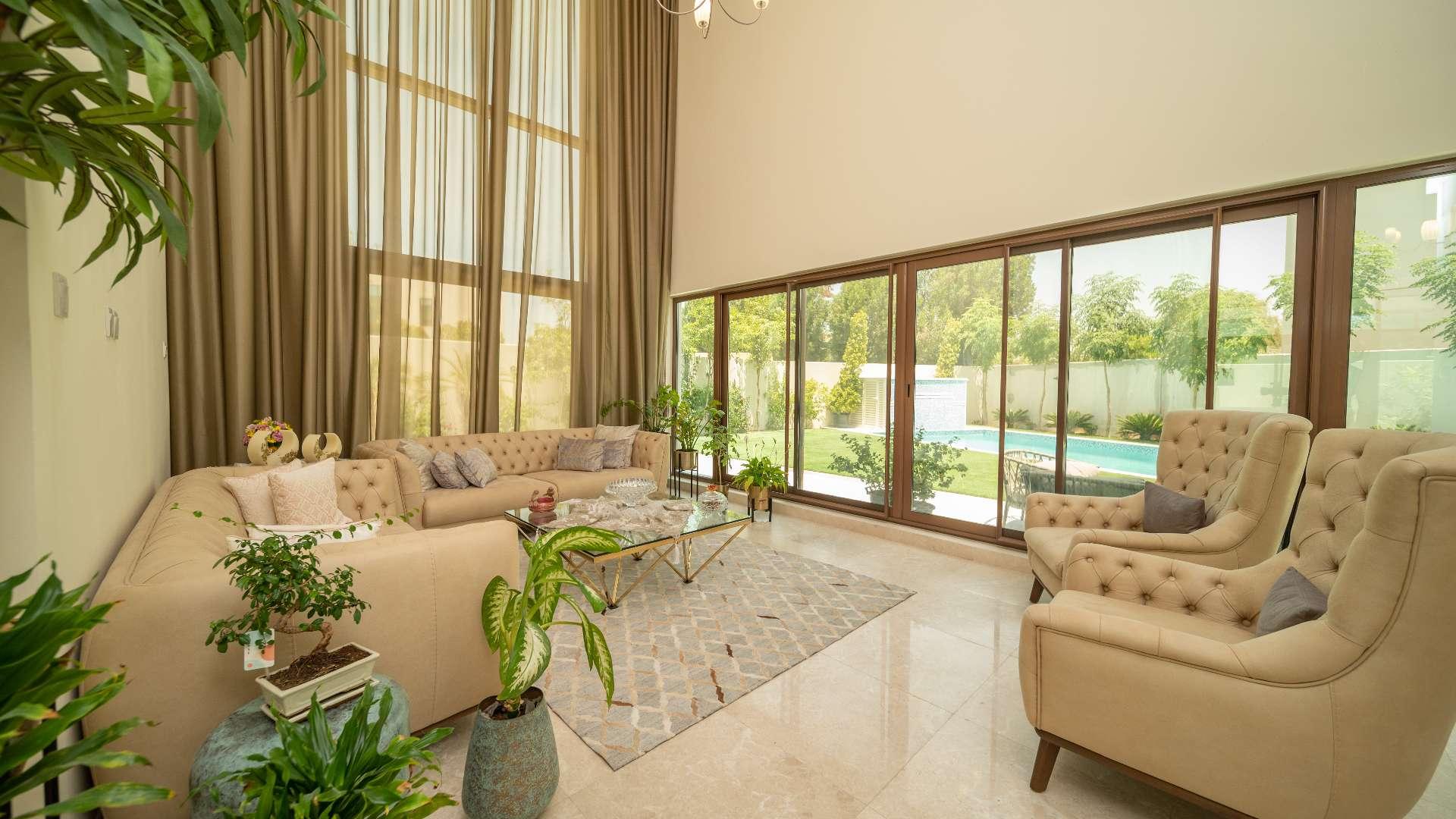 Elegant living room in Meydan villa with large windows and stylish decor