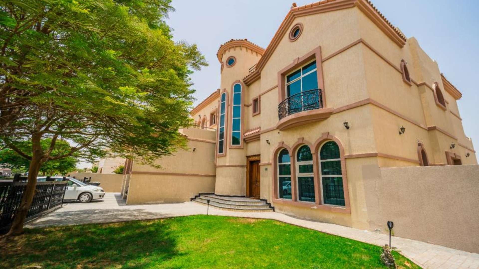 Stunning custom-built villa exterior with garden in Hacienda, The Villa community