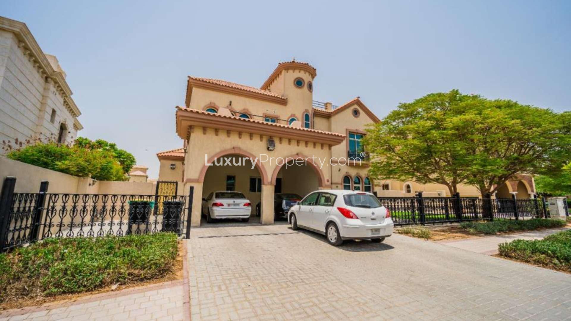 Stunning 6-bedroom villa exterior with lush garden in Hacienda, The Villa community