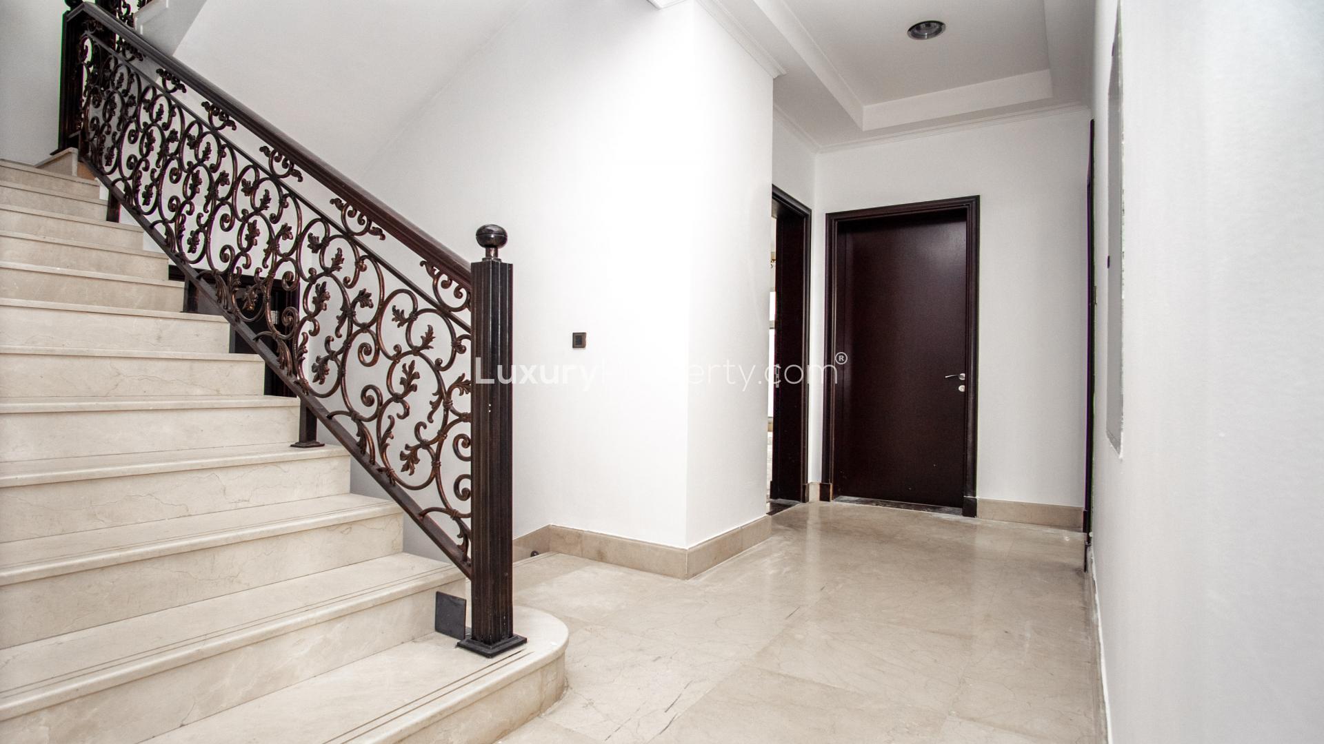 Marble staircase with ornate railing in Jumeirah 3 villa, six-bedroom rental property
