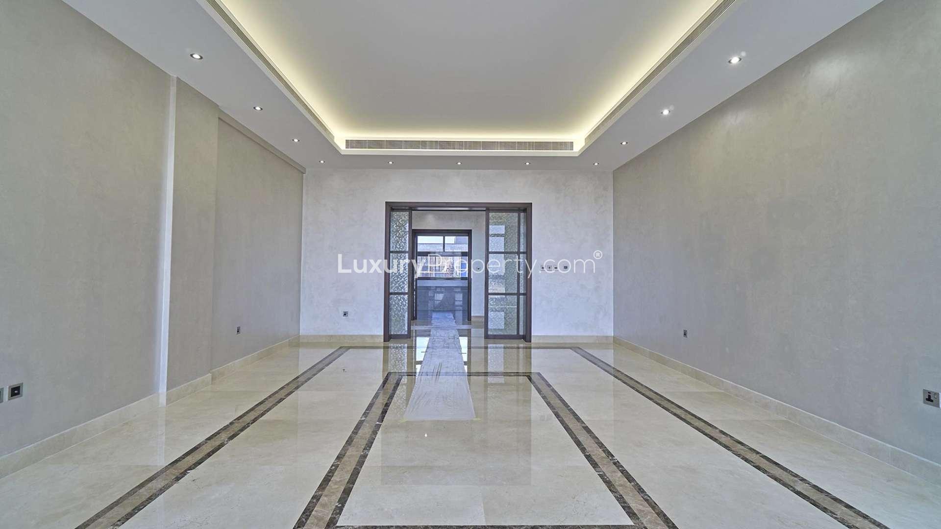 Modern custom-built mansion exterior in Dubai Hills Estate, featuring sleek design and lush landscaping