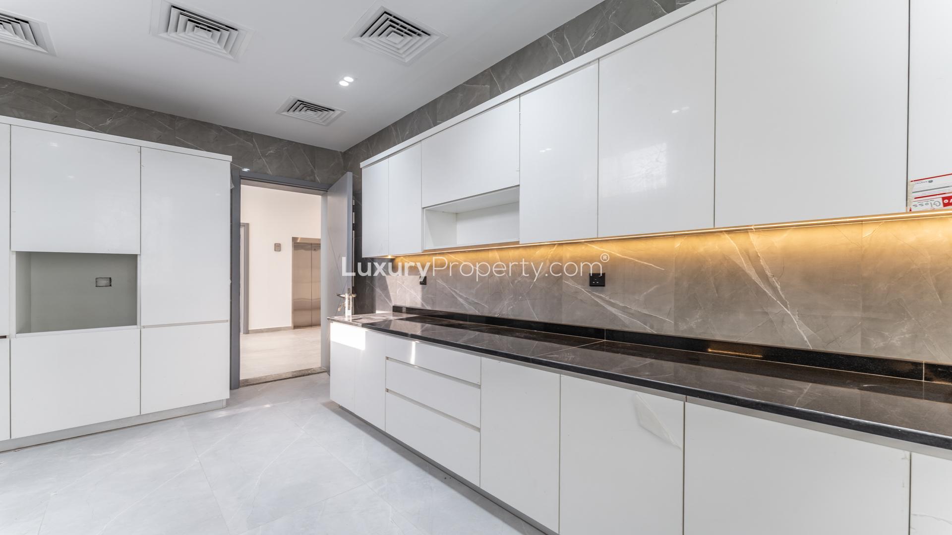 "Modern kitchen in brand new 6-bedroom villa, Al Barsha South 2, with sleek cabinetry.",Modern kitchen in brand new 6-bedroom villa, Al Barsha South 2, available for rent
