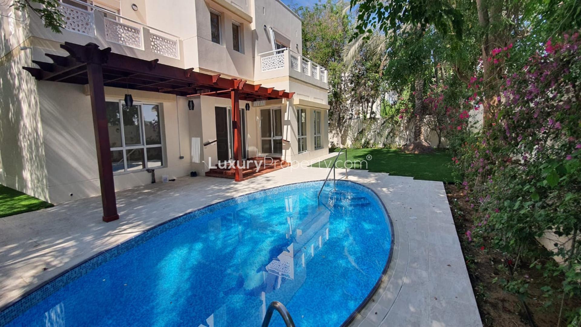 Backyard of upgraded 6-bedroom villa in Meadows 1, Dubai, featuring pool and garden