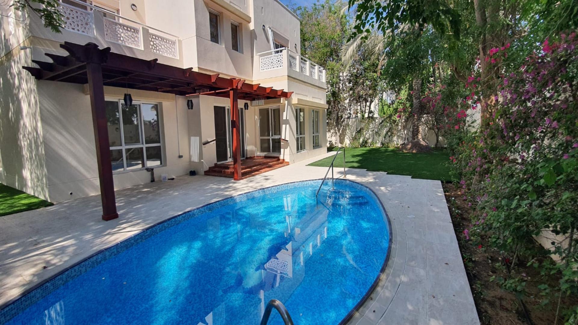 Backyard of upgraded 6-bedroom villa in Meadows 1, Dubai, featuring pool and garden
