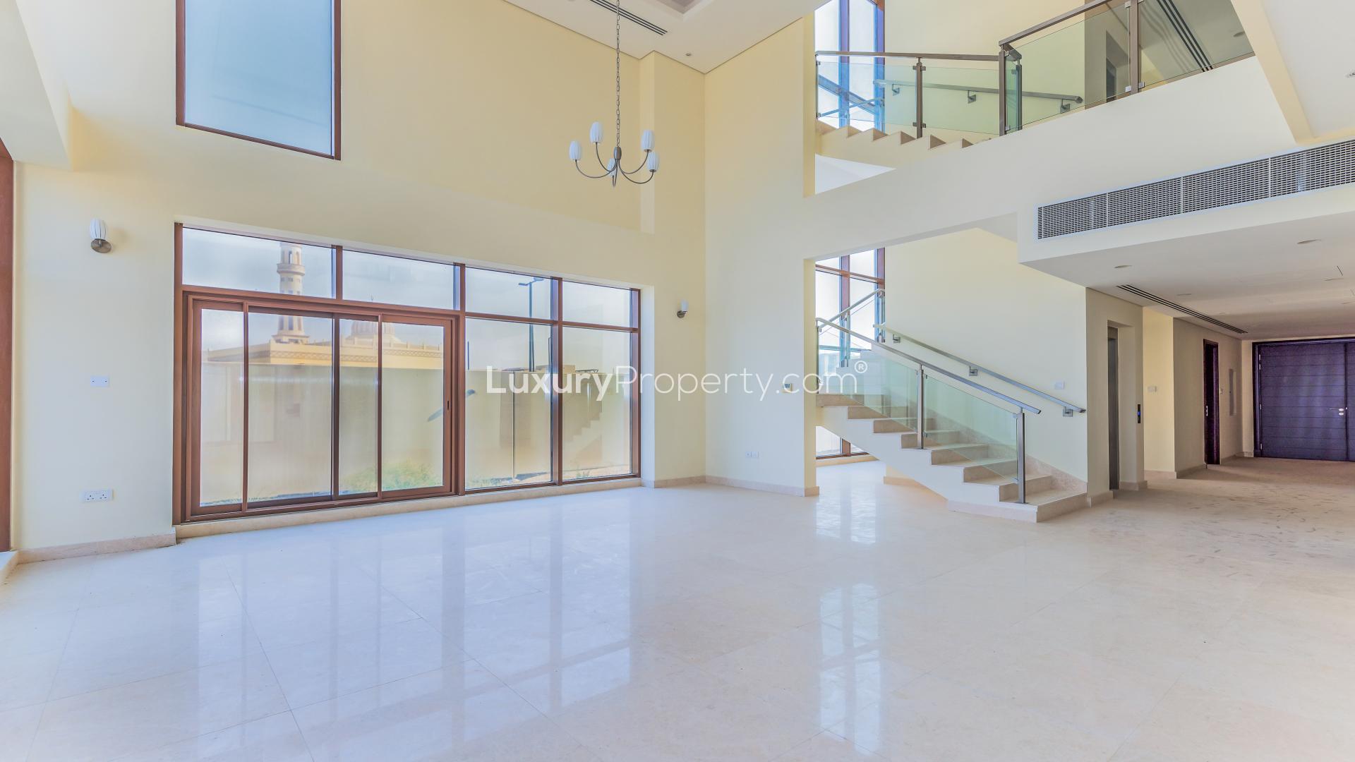 Spacious living room in Meydan villa with large windows and high ceiling