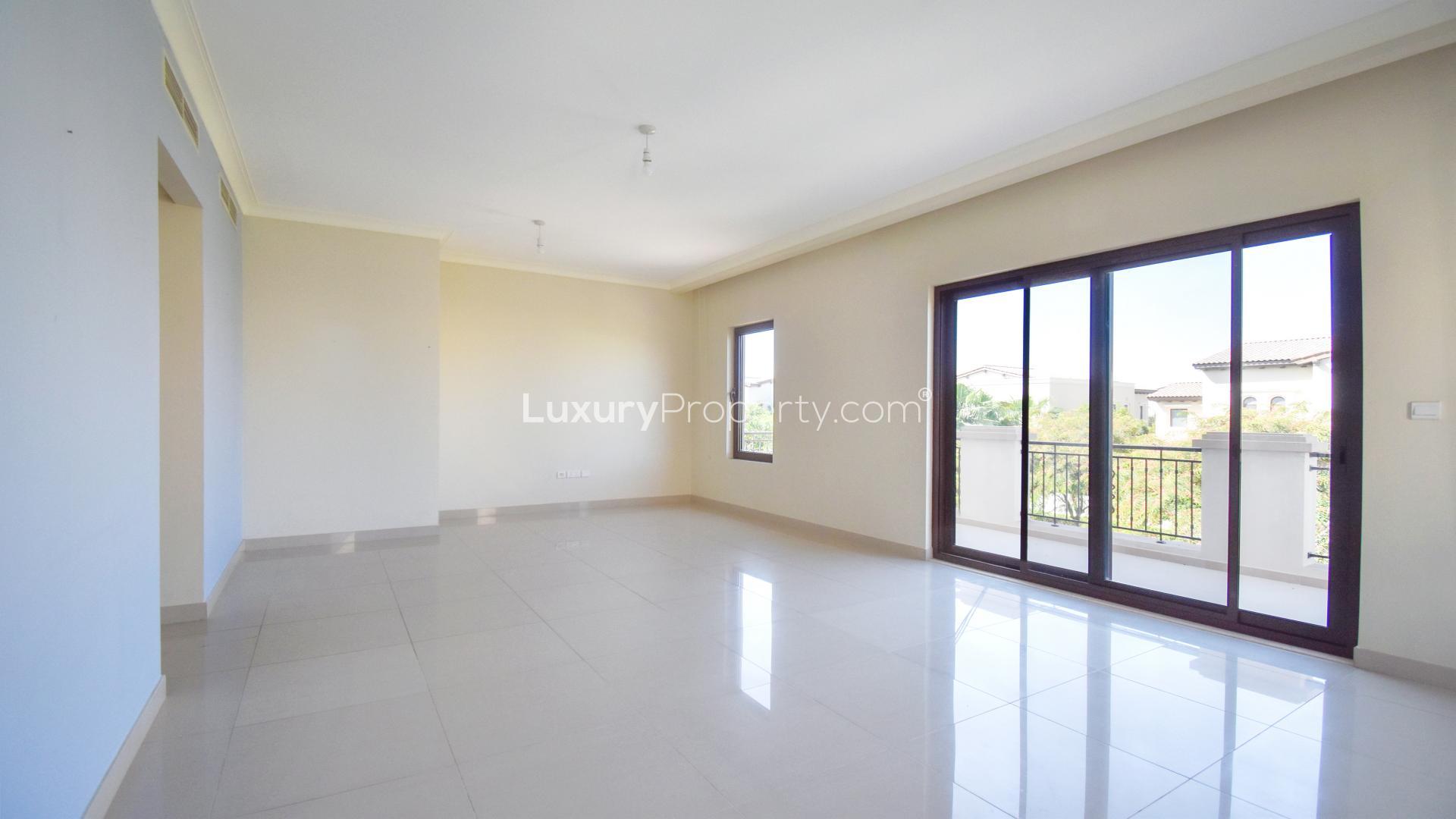 N/A,Empty living room in six-bed villa, Arabian Ranches 2, with large windows and tiled floor
